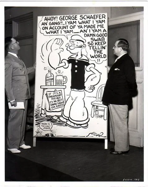 Max and unidentified person with large Popeye card. The Fleischer Family Collection