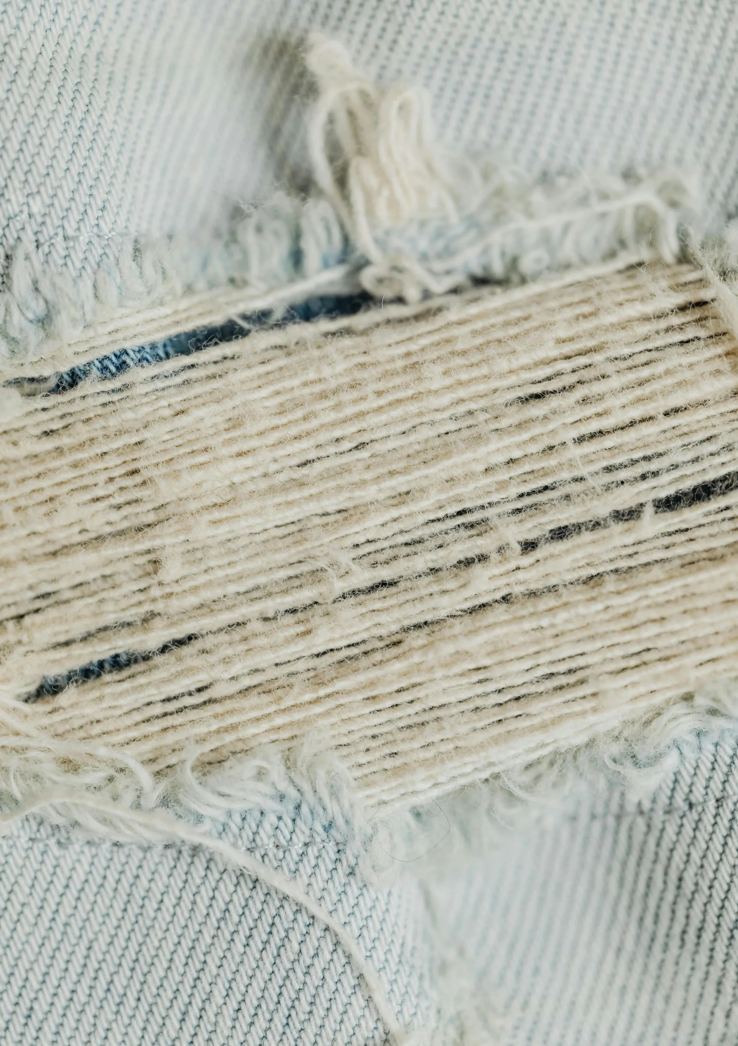 a close up of a tear in denim
