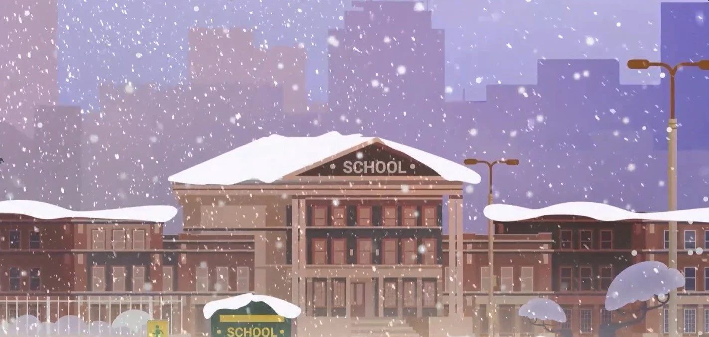 A school building with snow on the roof and falling snowflakes during winter.