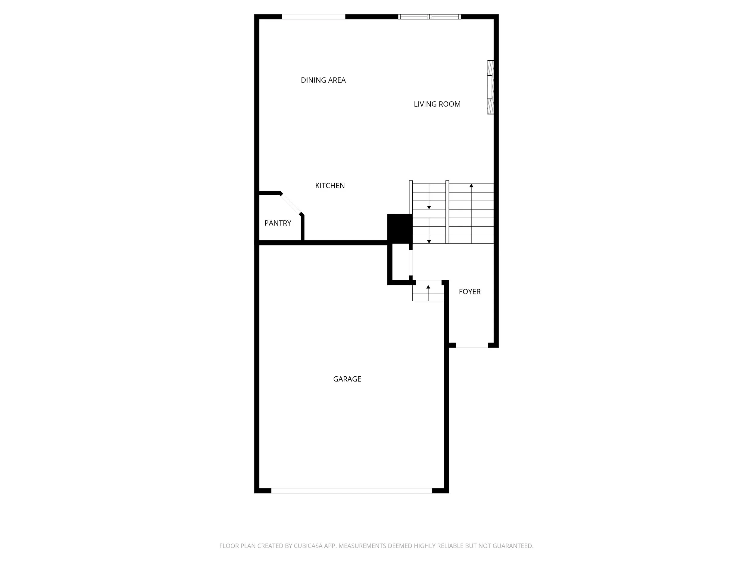 Floor plan of a house showing the garage, foyer, kitchen, pantry, living room, dining area, and staircase.