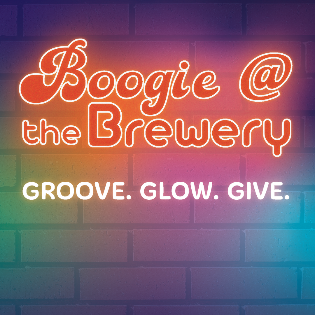 Neon sign that reads 'Bogie @ the Brewery' with the tagline 'GROOVE. GLOW. GIVE.' against a brick wall background.