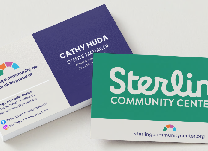 Business cards for Sterling Community Center and Cathy Huda Events Manager on a white surface.
