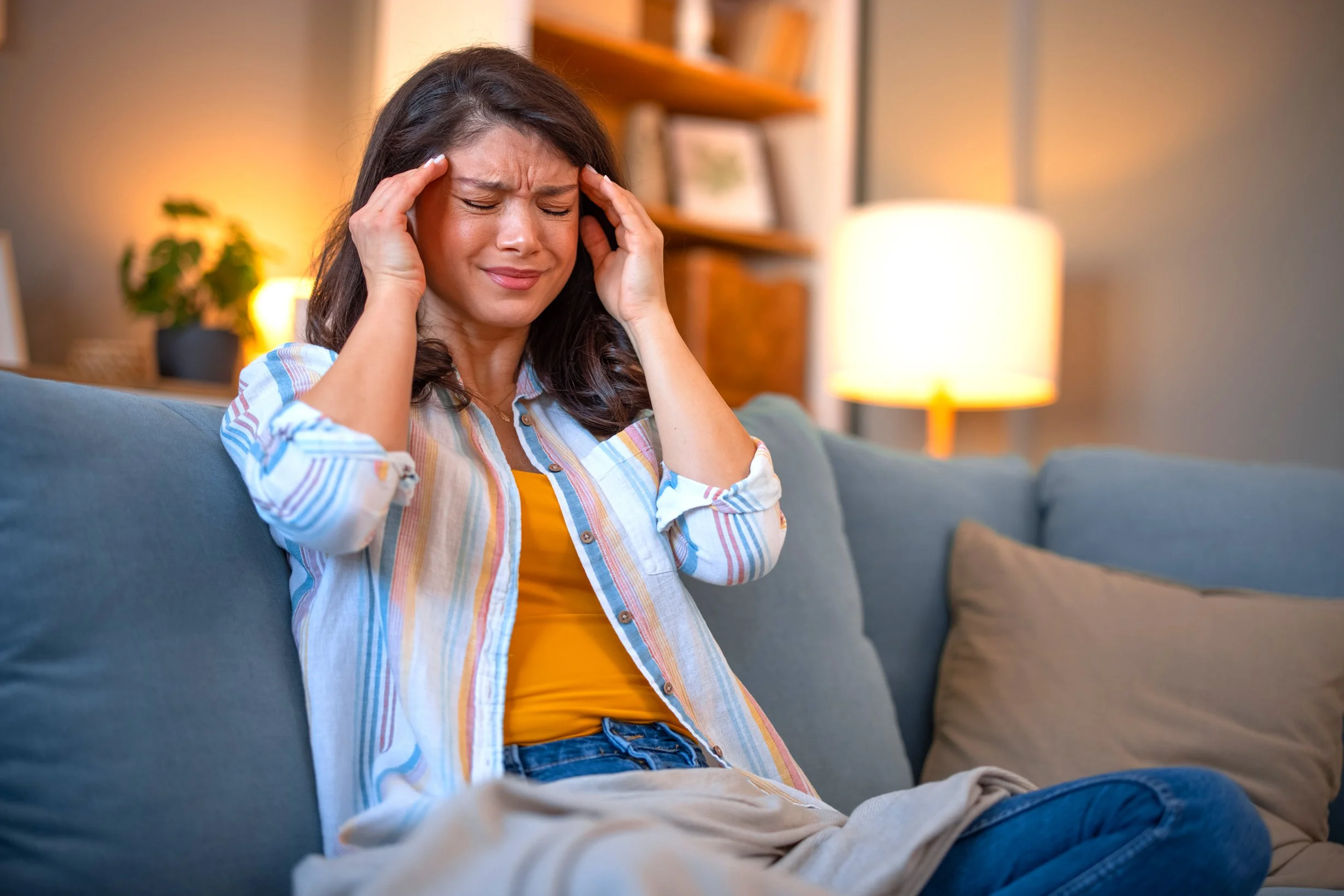 Woman with headache and neck pain seeking relief at RESET Walk-In Chiropractic in Sioux City