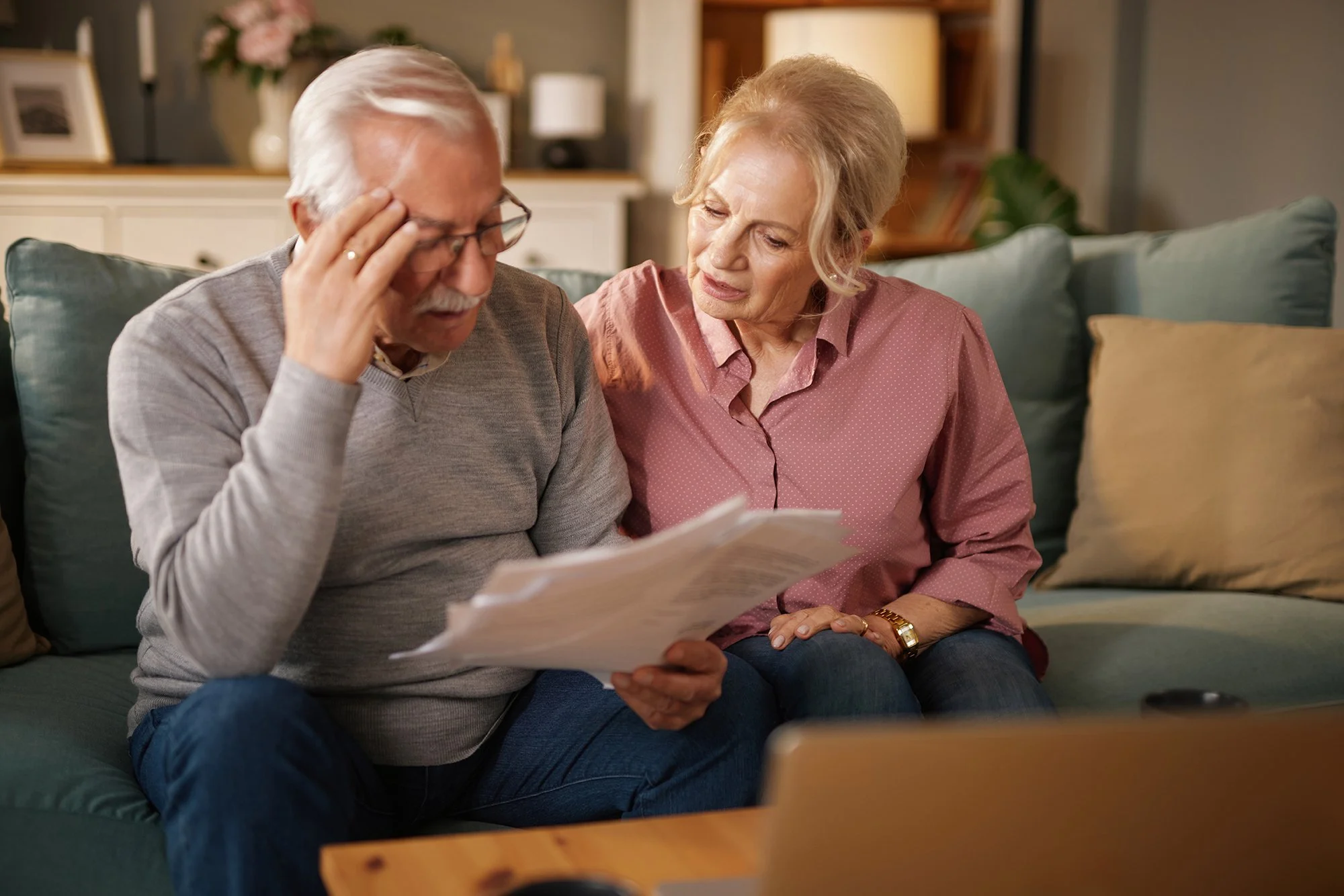 middle-aged couple appearing stressed while reviewing documents