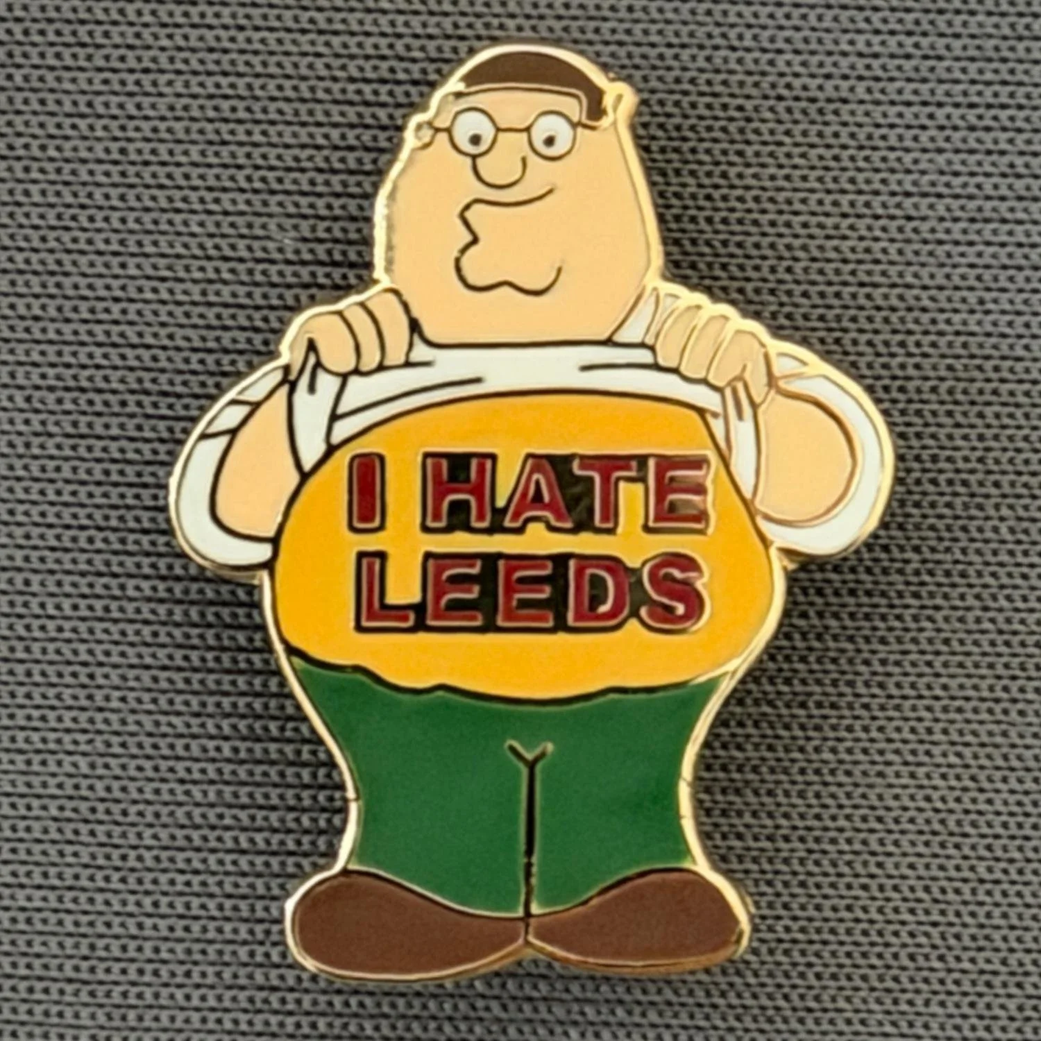 Reference Number: BCCTN036
Size: H 24.4 mm x W 18.6 mm
Pin Type: Brooch Pin
Plating: Gold
Value: £6
Manufacturer: Not Known
Comments: Pete Griffin Family Guy, I Hate Leeds, Amber & Claret