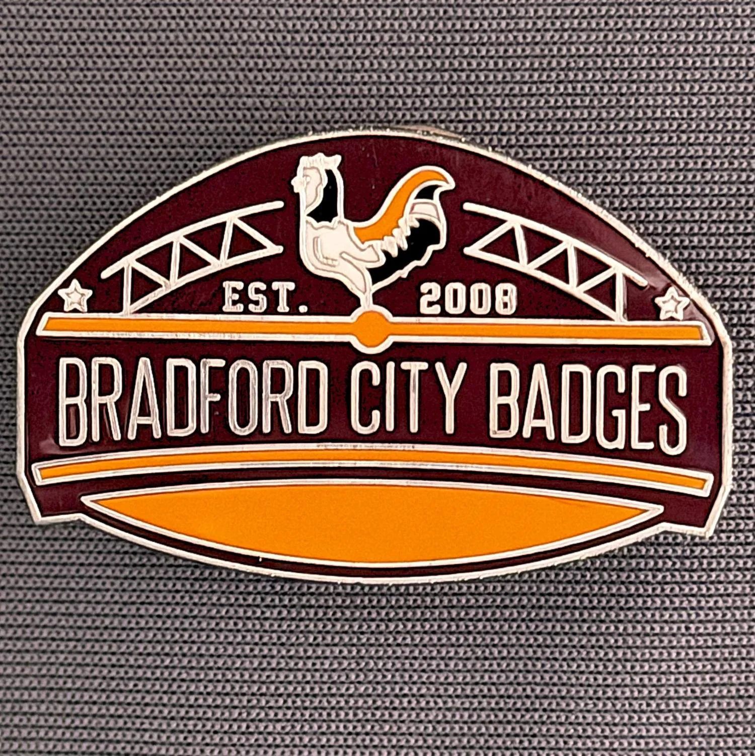 Reference Number: BCUN055
Size: H 20.5 mm x W 32 mm
Pin Type: Metal Clutch
Plating: Antique Silver
Value: £10
Manufacturer: Bradford City Badges
Comments: Bradford City Badges Badge, Limited Edition of 1.