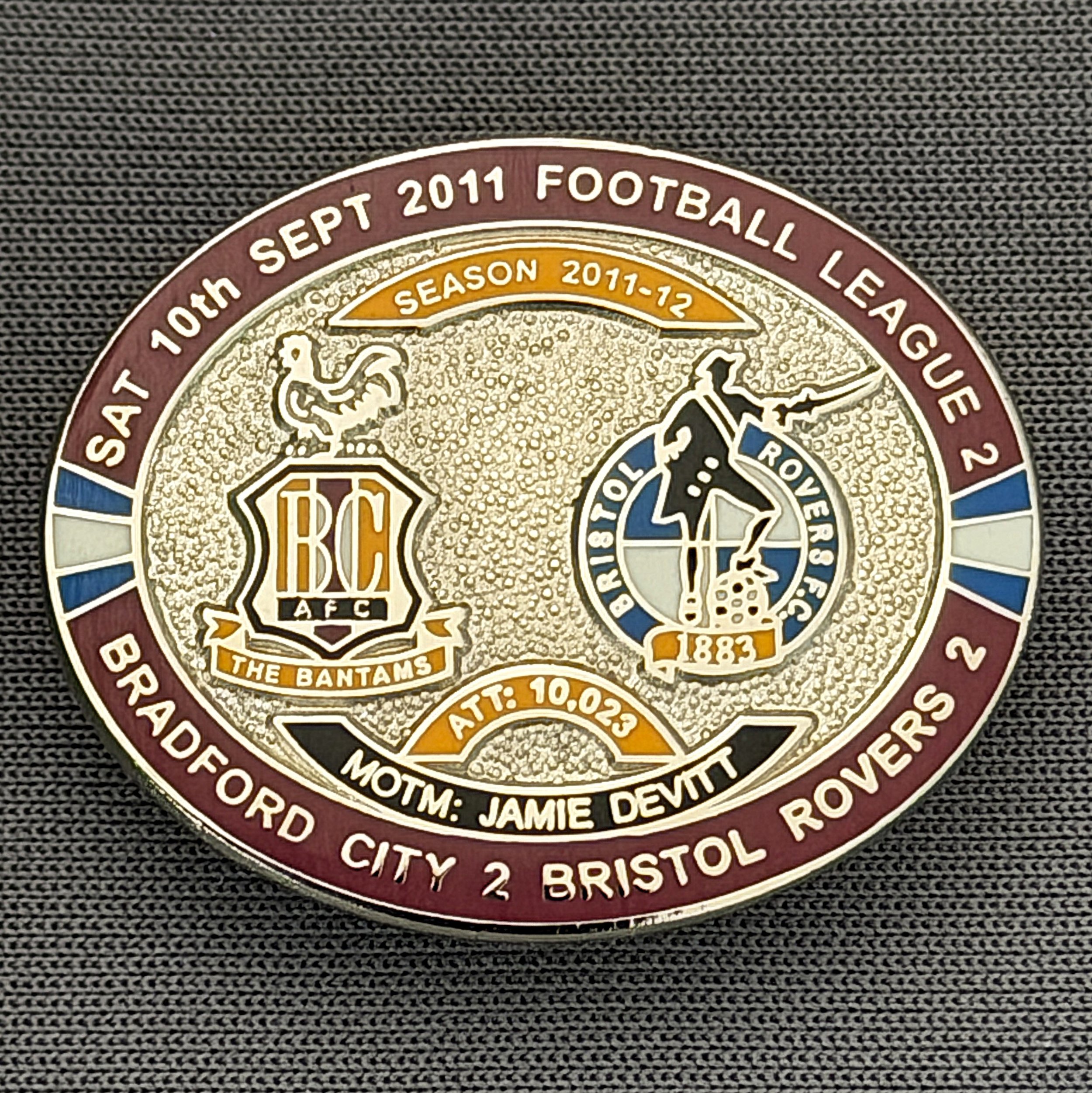 Reference Number: BCFIX096
Size: H 23.6 mm x W 28.7 mm
Pin Type: Brooch Pin
Plating: Silver
Value: £10
Manufacturer: Bradford City Badges
Comments: Bradford City v Bristol Rovers  2011/12 Limited Edition 20 Badges (Silver Version)