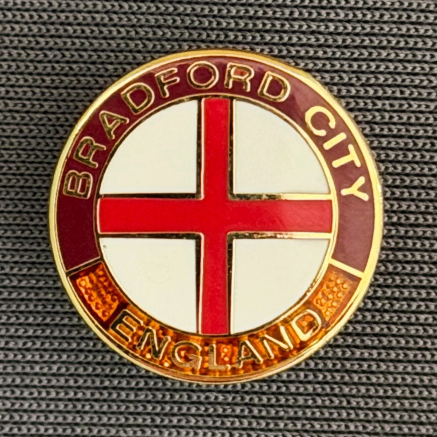 Reference Number: BCFLA021
Size: D 15.3 mm
Pin Type: Metal Clutch
Plating: Gold
Value: £6
Manufacturer: Andy Stokes
Comments: Circular St George Cross, Bradford City, England, Claret & Amber