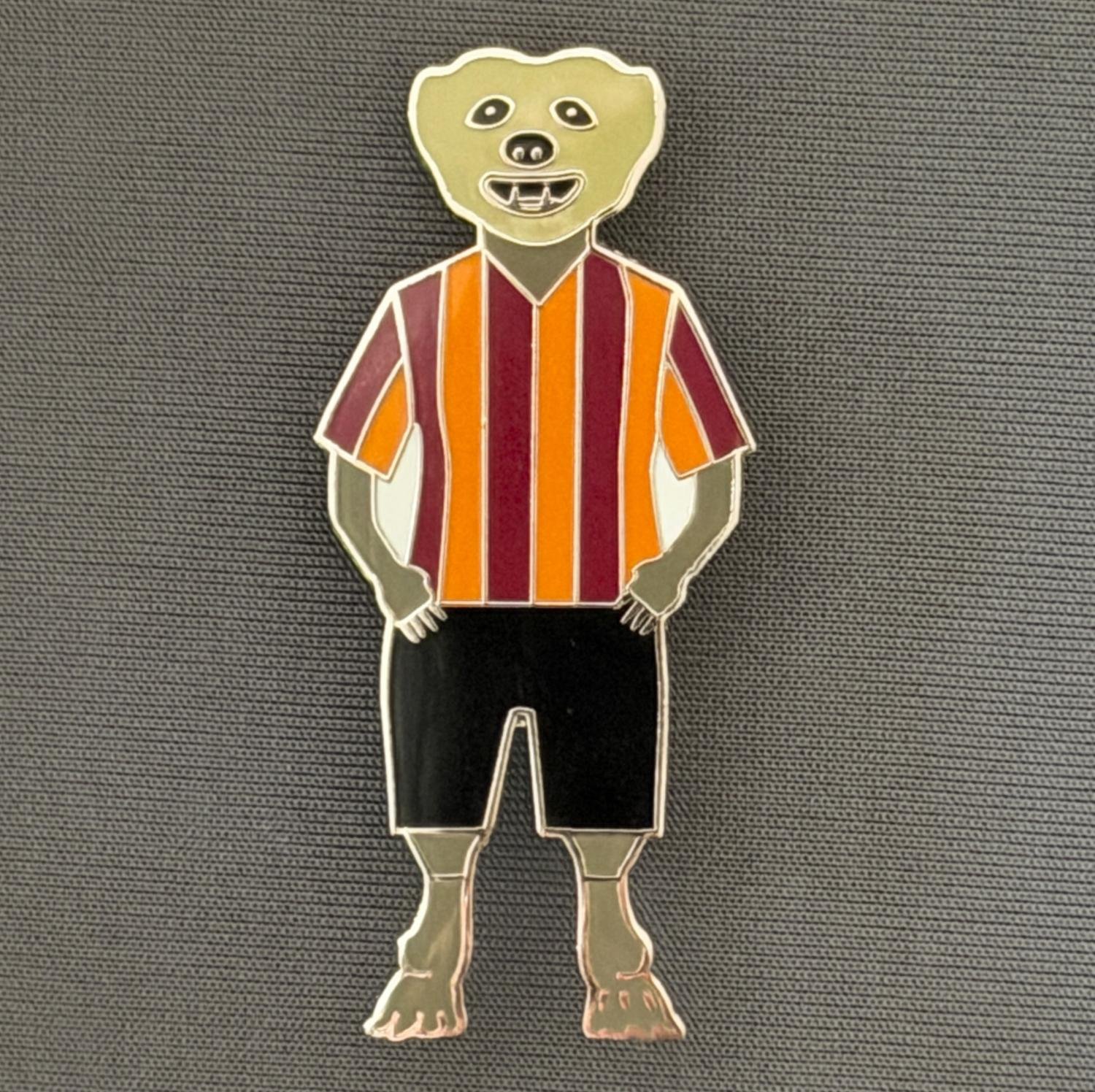 Reference Number: BCCTN035
Size: H 50.2 mm x W 22.3 mm
Pin Type: Brooch Pin
Plating: Silver
Value: £6
Manufacturer: Not Known
Comments: Bear Character in Bradford City Kit