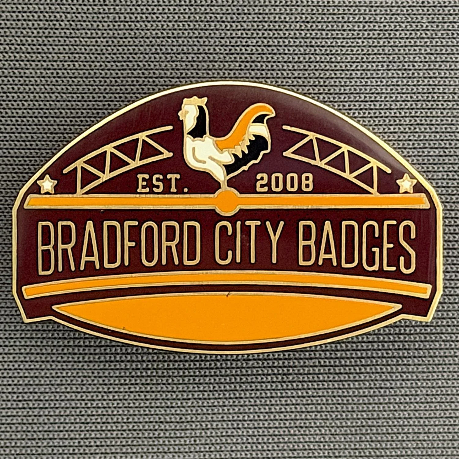Reference Number: BCUN051
Size: H 20.5 mm x W 32 mm
Pin Type: Metal Clutch
Plating: Antique Gold
Value: £10
Manufacturer: Bradford City Badges
Comments: Bradford City Badges Badge, Limited Edition of 1.