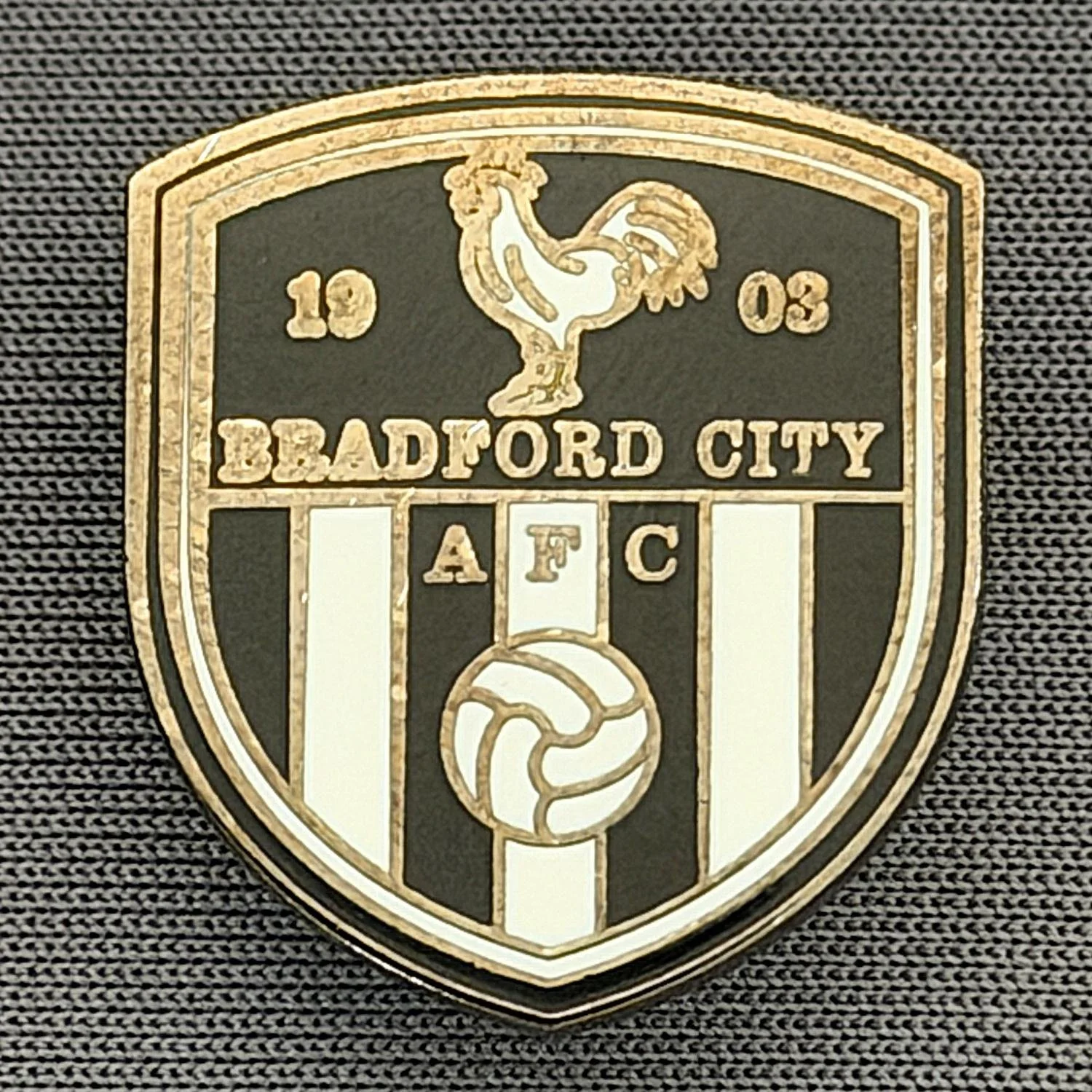 Reference Number: BCC&L159
Size: H 22 mm x 19.5 mm
Pin Type: Brooch Pin
Plating: Black Nickel
Value: £6
Manufacturer: Unknown
Comments: Bradford City Crest Shield Black & White