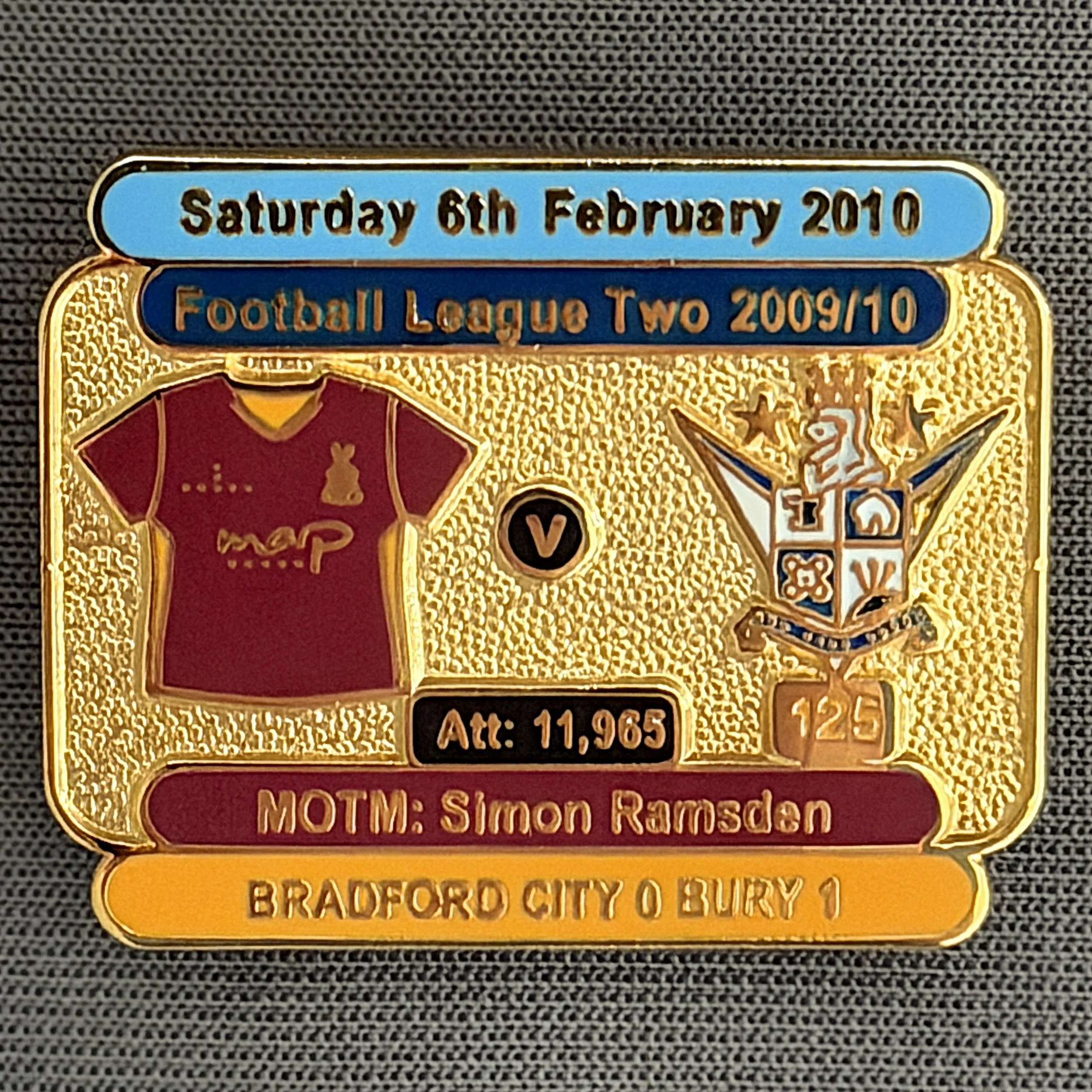 Reference Number: BCFIX037
Size: H 23.1 mm x W 29 mm
Pin Type: Brooch Pin
Plating: Gold
Value: £8
Manufacturer: Bradford City Badges
Comments: Bradford City v Bury 2009/10 Limited Edition 100 Badges