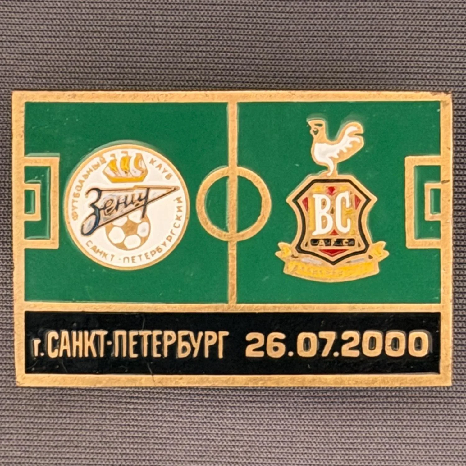 Reference Number: BCRUS002
Size: H 29.4 mm x W 44 mm
Pin Type: Metal Clutch
Plating: Antique Gold
Value: £12
Manufacturer: Unknown
Comments: Zenit St. Petersburg Inter Toto Cup, Black