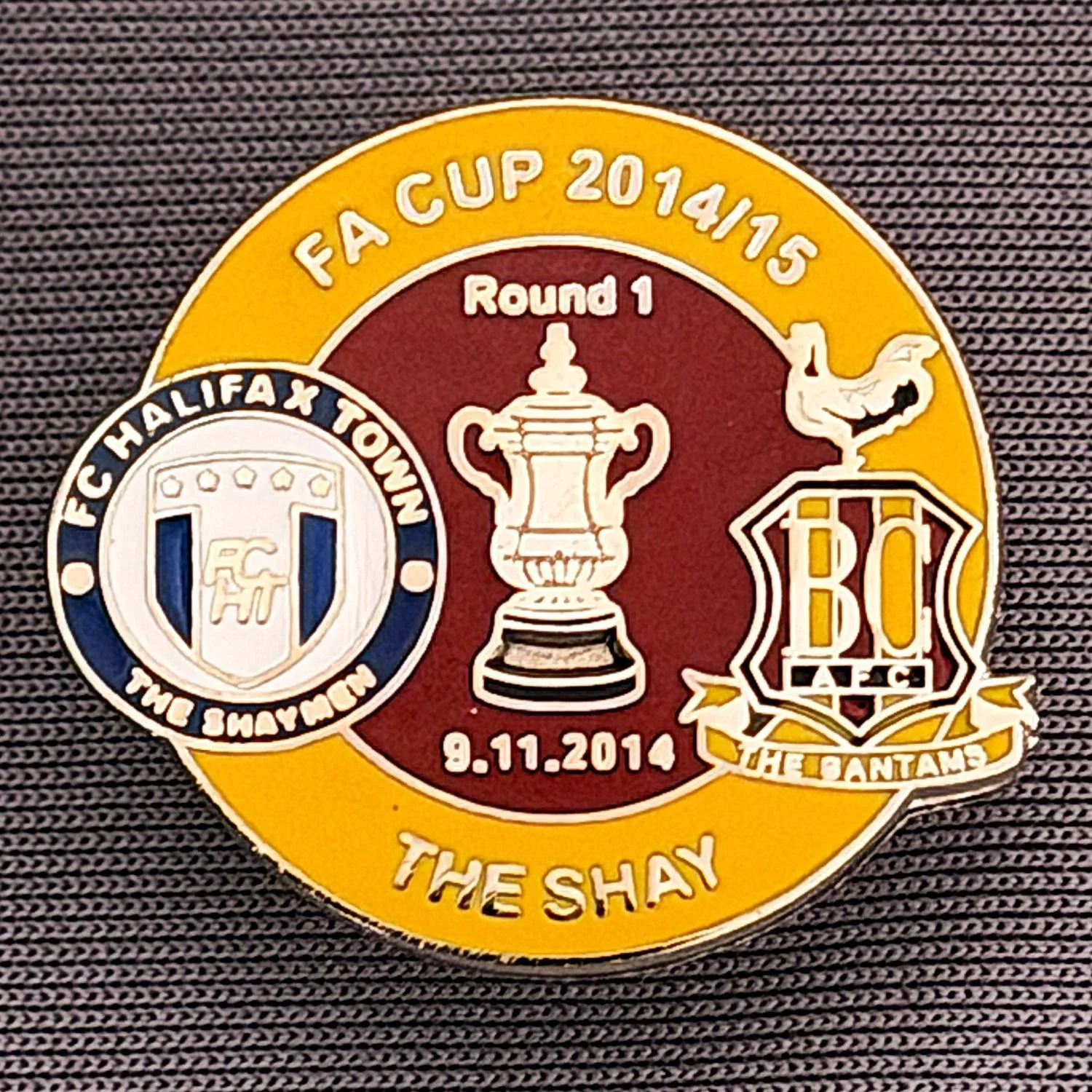 Reference Number: BCFAC052
Size: H 22. 7 mm x W 25.8 mm
Pin Type: Metal Clutch
Plating: Silver
Value: £4
Manufacturer: Dan Lloyd
Comments: F.A. Cup 2014/15 Away v Halifax Town, Amber & Claret Version