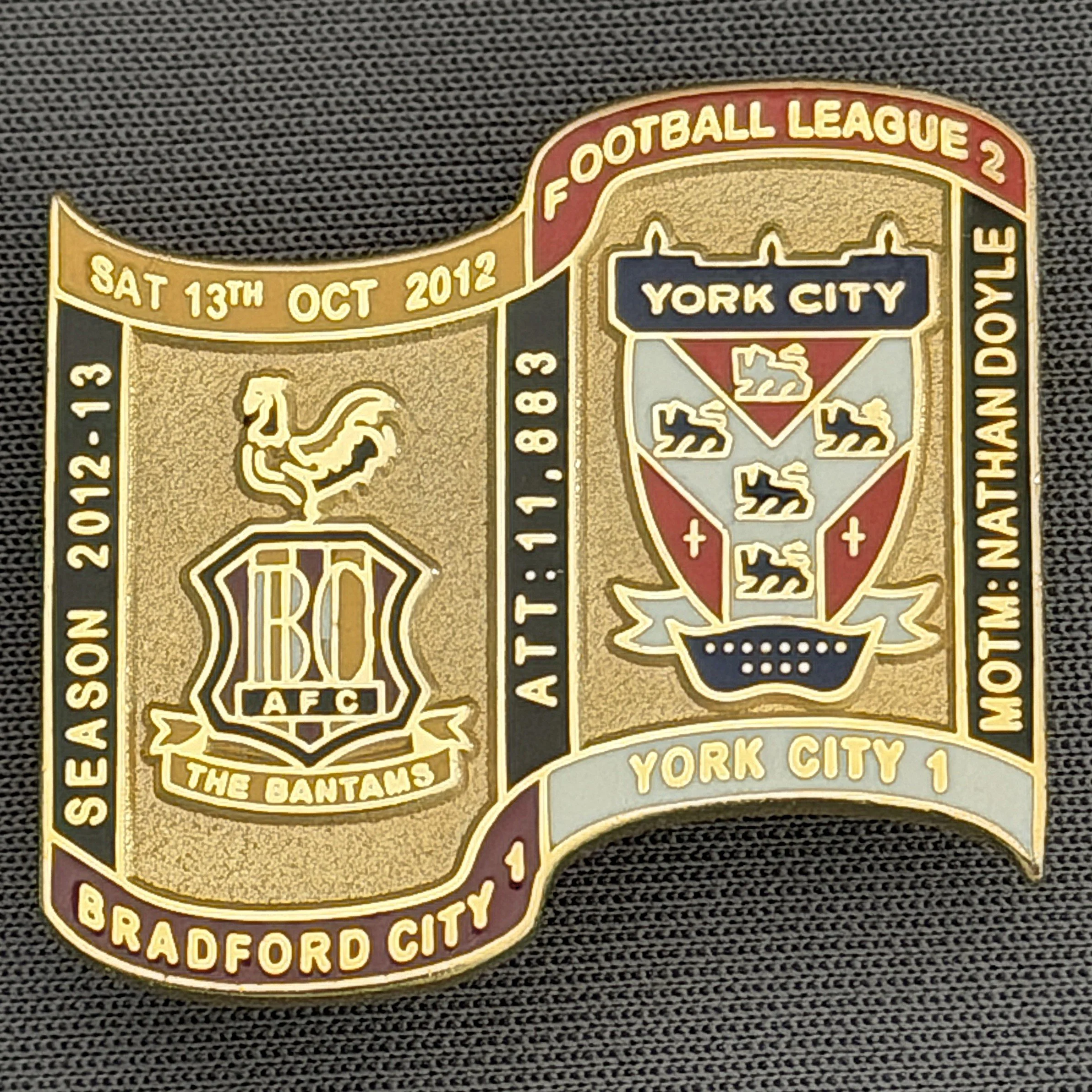 Reference Number: BCFIX121
Size: H 26.9 mm x W 29.2 mm
Pin Type: Brooch Pin
Plating: Gold
Value: £8
Manufacturer: Bradford City Badges
Comments: Bradford City v York City 2012/13 Limited Edition 65 Badges