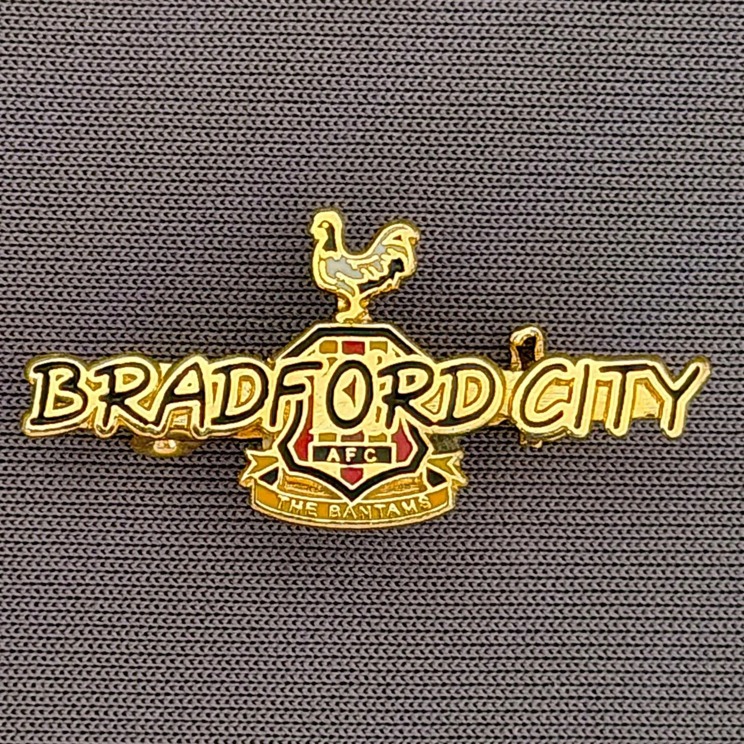 Reference Number: BCC&L046
Size: H 14 mm x 29.9 mm
Pin Type: Brooch Pin
Plating: Gold
Value: £8
Manufacturer: Unknown
Comments: Black Bradford City Logo