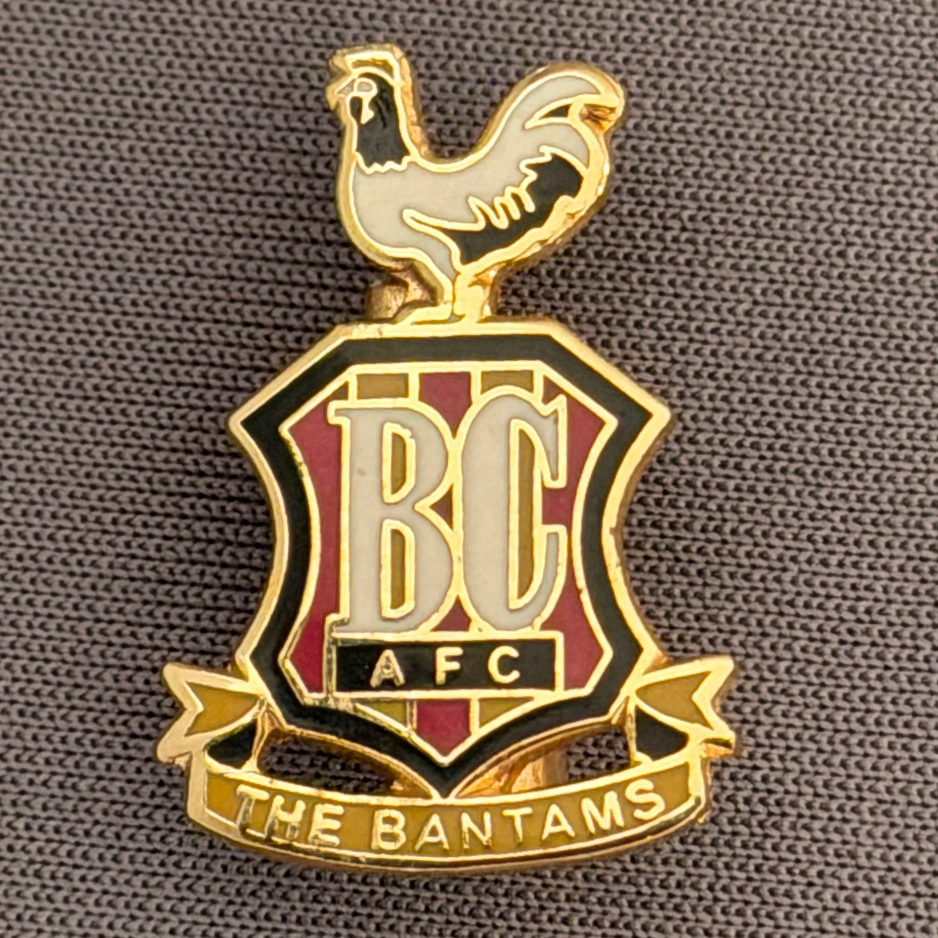 Reference Number: BCC&L076
Size: H 24.8 mm x 22.2  mm
Pin Type: Metal Clutch
Plating: Gold
Value: £8
Manufacturer: Unknown
Comments: Classic BCAFC Logo