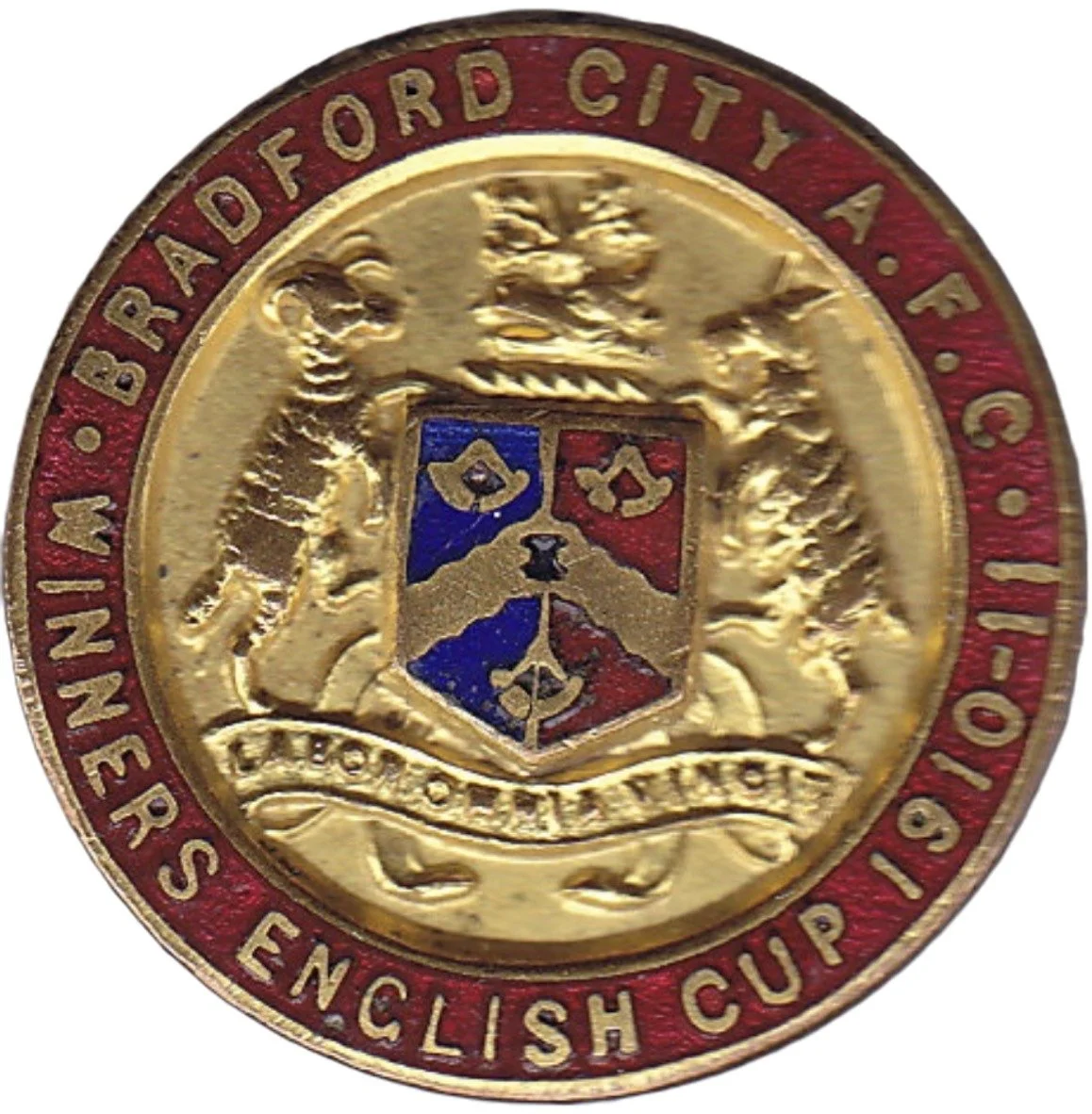 Gold-colored medal for the Briadford City A.F.C. English Cup 1910, featuring a shield with a dog and a crown, encircled by a red border with gold lettering.