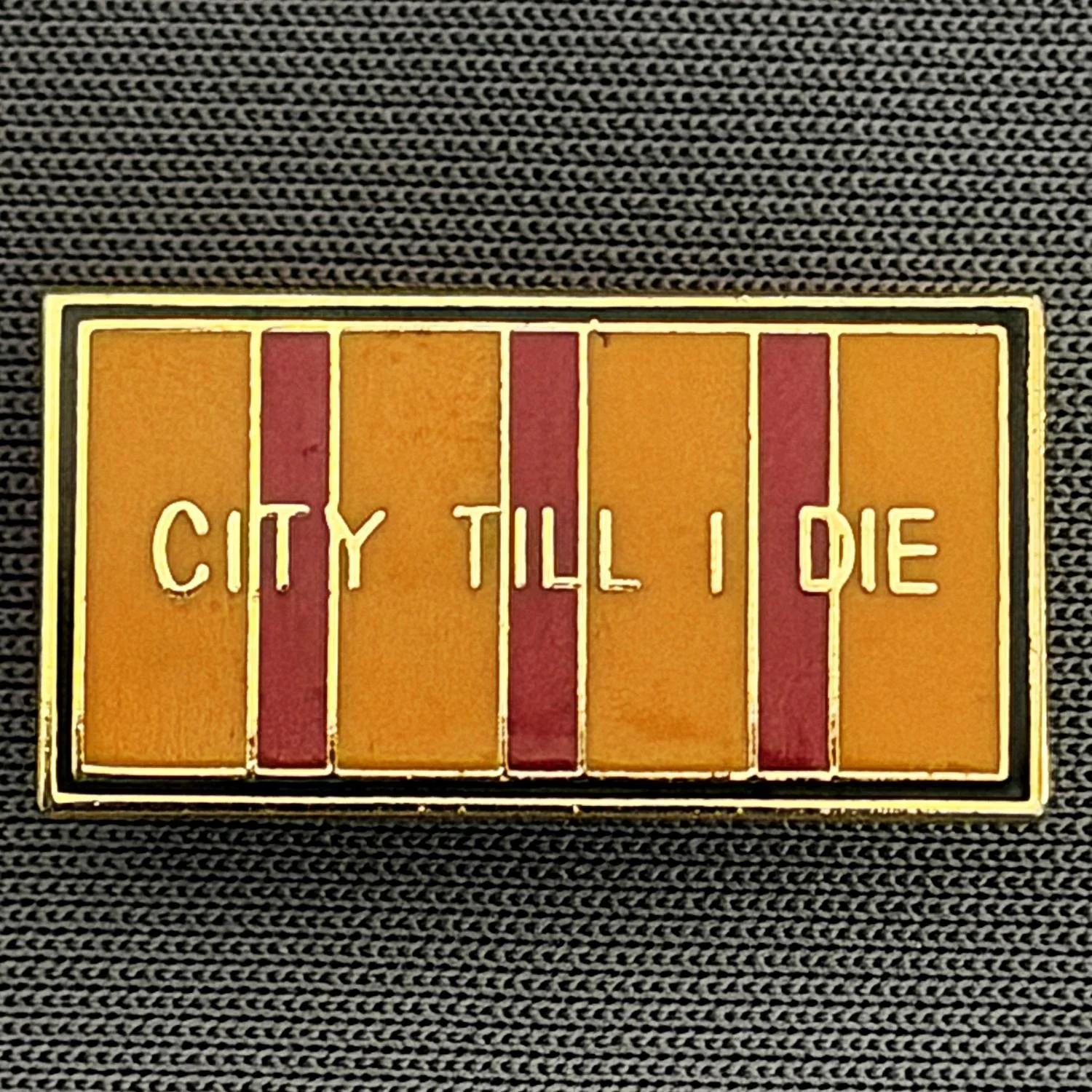 Reference Number: BCBCFC029
Size: H 11.5 mm x W 22.1 mm
Pin Type: Brooch Pin
Plating: Gold
Value: £6
Manufacturer: Unknown
Comments: City Till I Die, Small Typeface