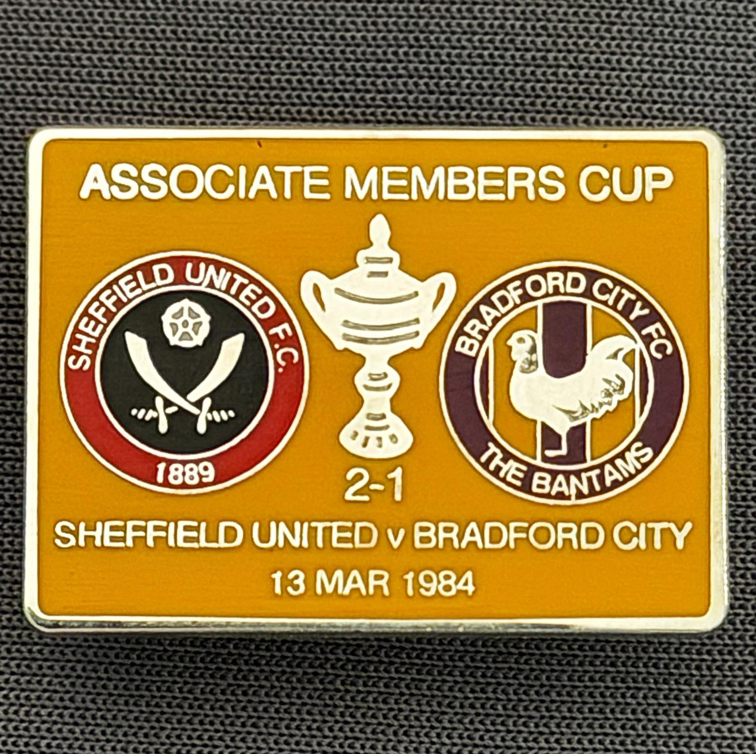 Reference Number: BCOFIX058
Size: H 18.9 mm x W 25.9 mm
Pin Type: Brooch Pin
Plating: Silver
Value: £6
Manufacturer: Unknown
Comments: Sheffield United v Bradford City Associate Members Cup 1984, Amber Version
