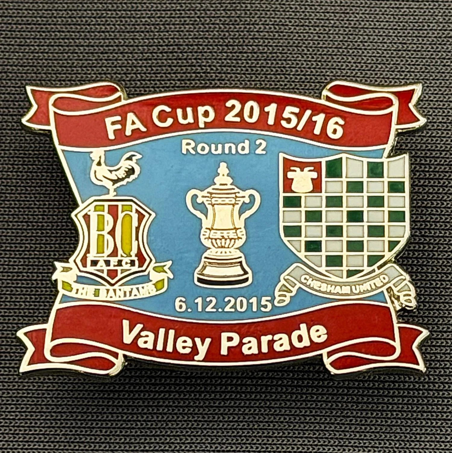 Reference Number: BCFAC146
Size: H 24.5 mm x W 32.5 mm
Pin Type: Metal Clutch
Plating: Silver
Value: £4
Manufacturer: Dan Lloyd
Comments: F.A. Cup Second Round 2015/16 v Chesham United, Red & Blue Version