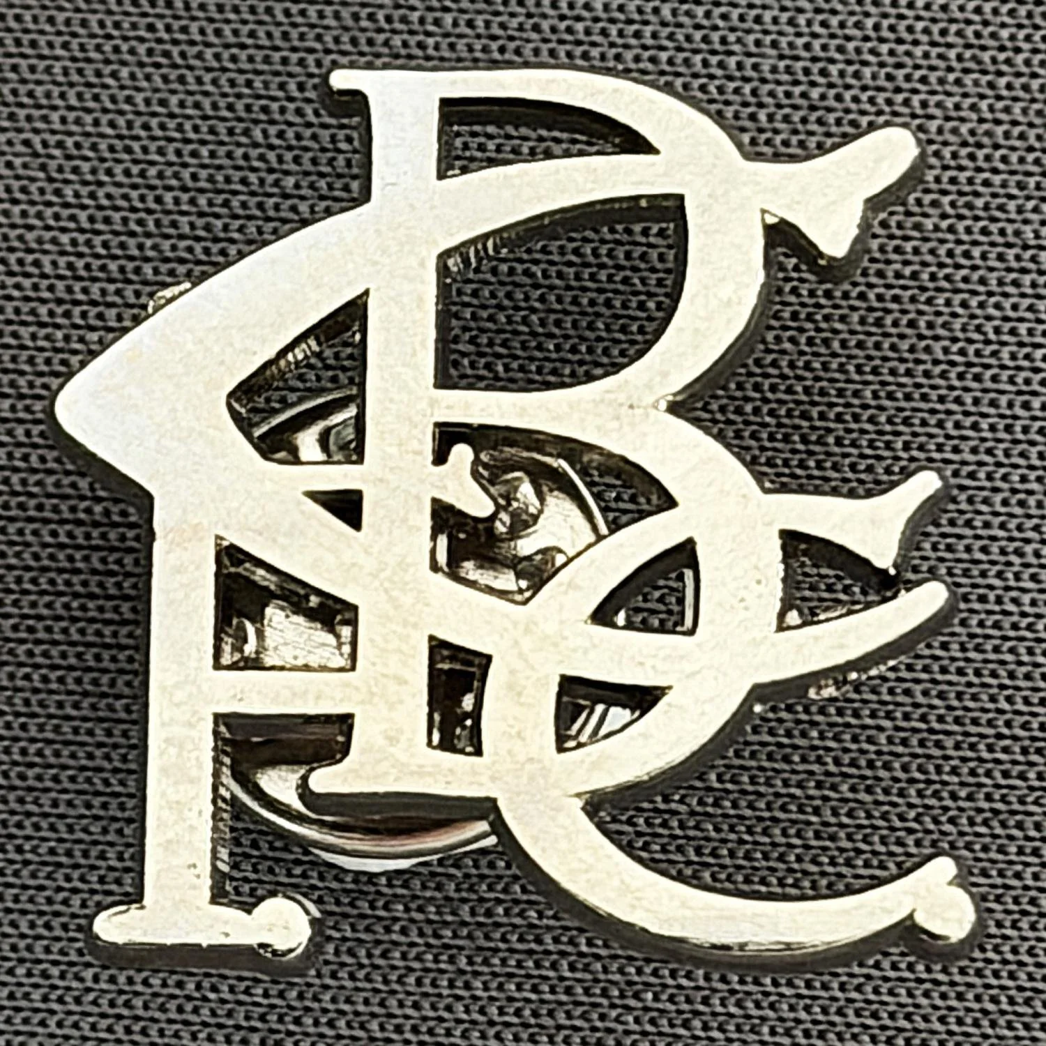 Reference Number: BCC&L066
Size: H 21.8 mm x 23.5 mm
Pin Type: Metal Clutch
Plating: Silver
Value: £6
Manufacturer: Unknown
Comments: BCFC Scroll Silver