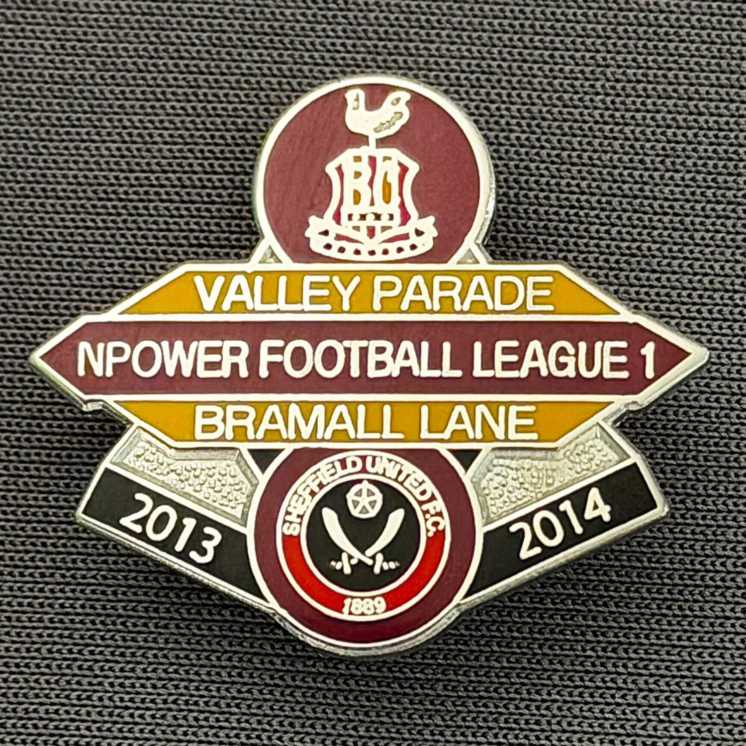 Reference Number: BCOFIX081
Size: H 22.5 mm x W 25.6 mm
Pin Type: Brooch Pin
Plating: Chrome
Value: £5
Manufacturer: Unknown
Comments: Bradford City v Sheffield United, League One, Claret & Amber Version