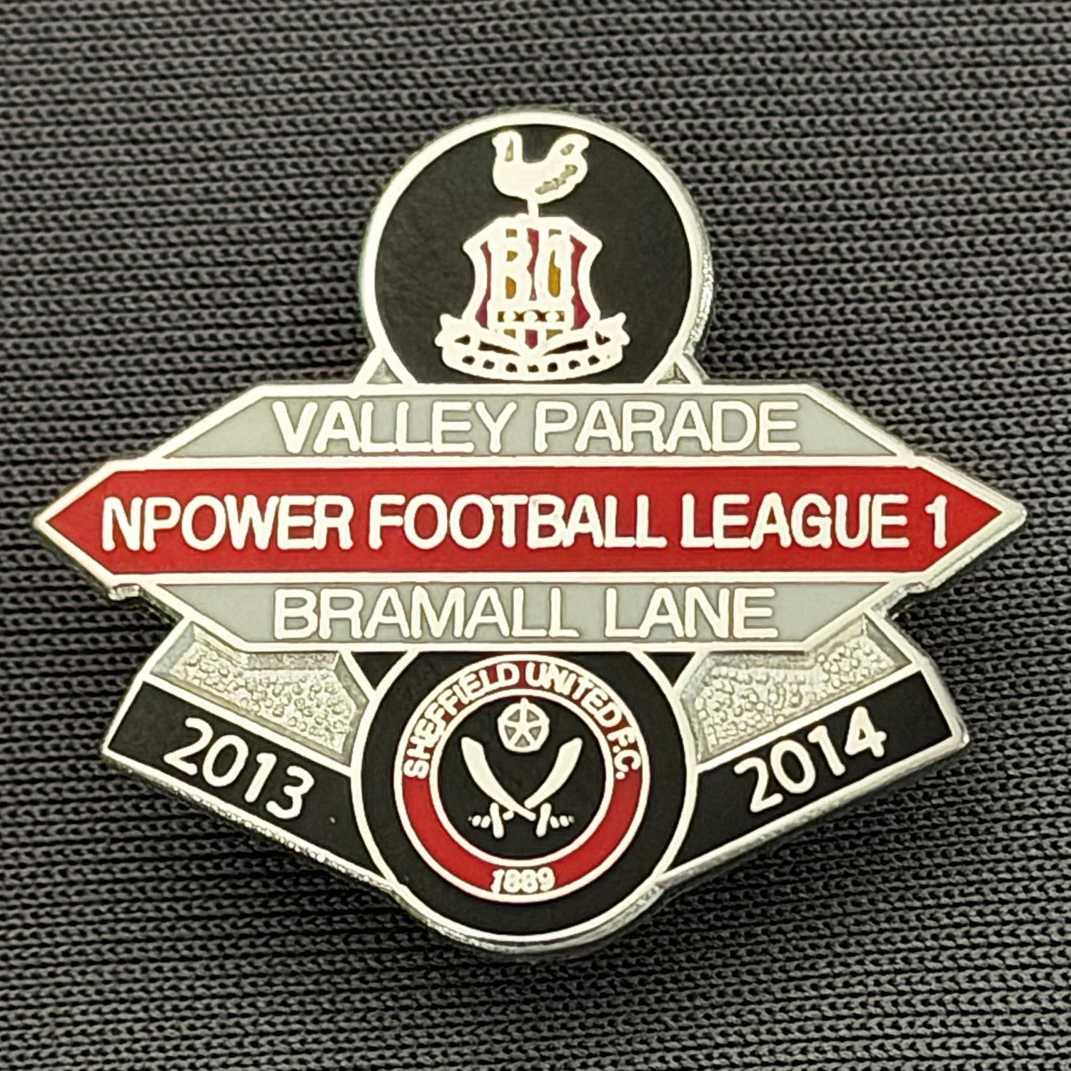 Reference Number: BCOFIX085
Size: H 22.5 mm x W 25.6 mm
Pin Type: Brooch Pin
Plating: Chrome
Value: £5
Manufacturer: Unknown
Comments: Bradford City v Sheffield United, League One, Black, White & Red Version