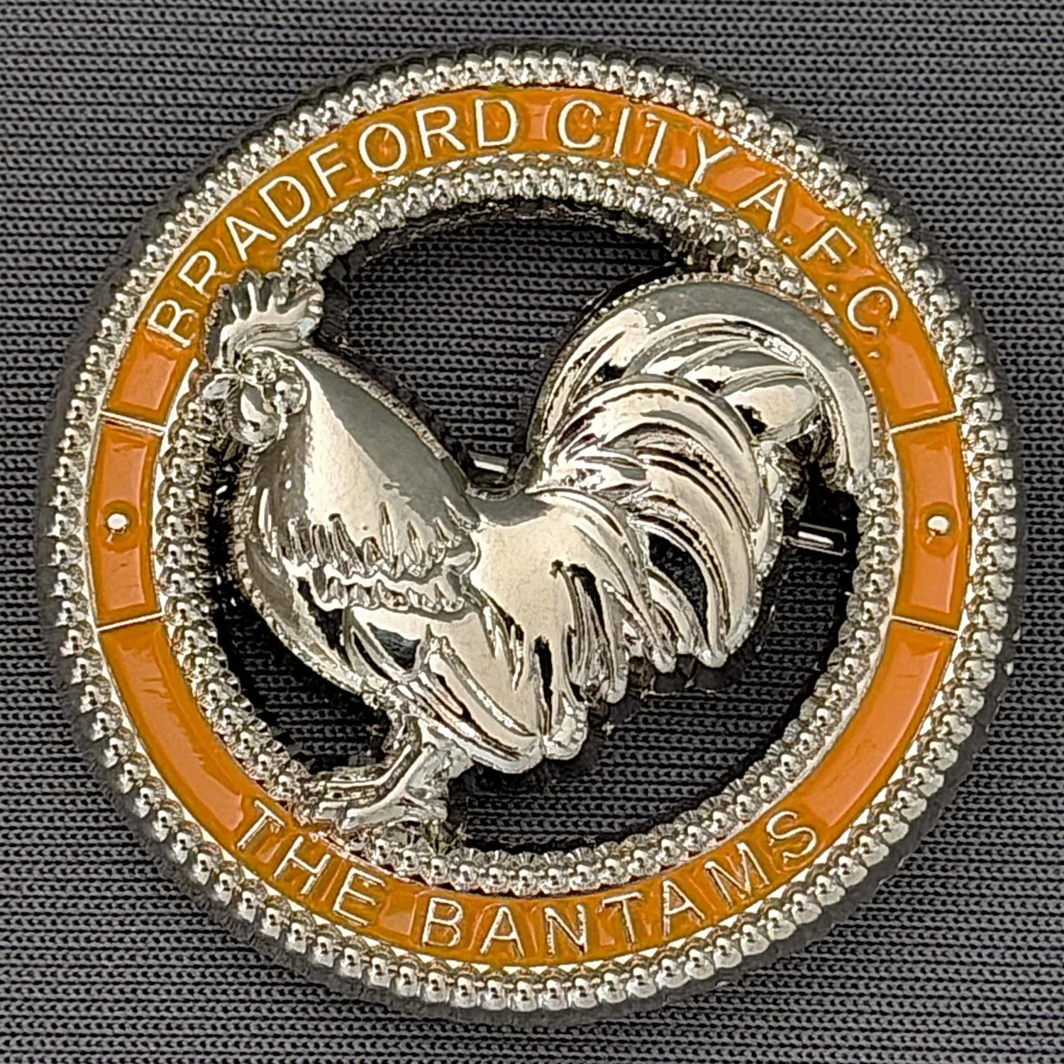 Reference Number: BCBAN077
Size: D 35.3 mm
Pin Type: Brooch Pin
Plating: Silver
Value: £12
Manufacturer: Bradford City Badges
Comments: 3D Amber, Cut out Bantam. Limited Edition of 6 Badges.