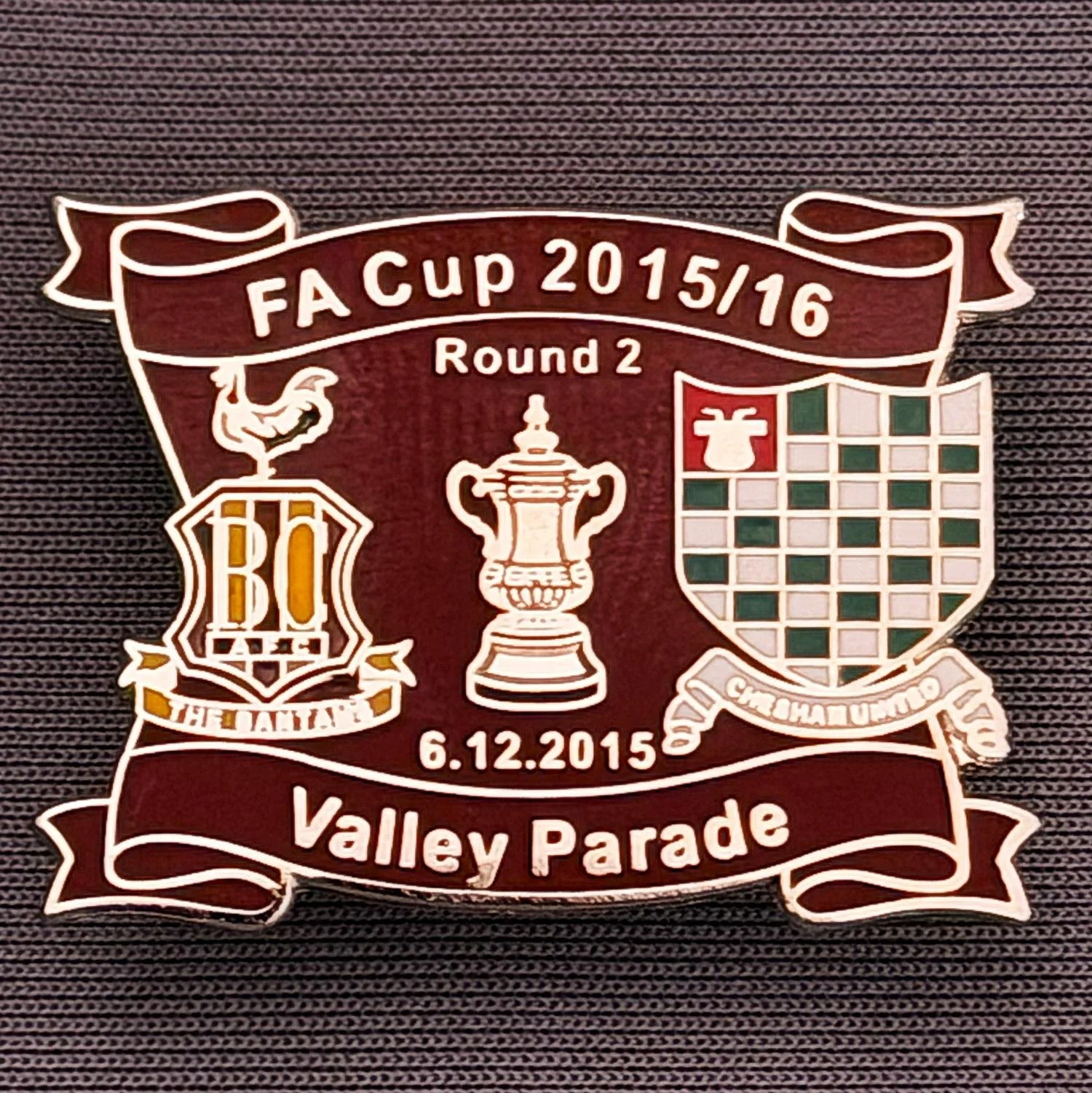 Reference Number: BCFAC140
Size: H 24.5 mm x W 32.5 mm
Pin Type: Metal Clutch
Plating: Silver
Value: £4
Manufacturer: Dan Lloyd
Comments: F.A. Cup Second Round 2015/16 v Chesham United, Claret Version