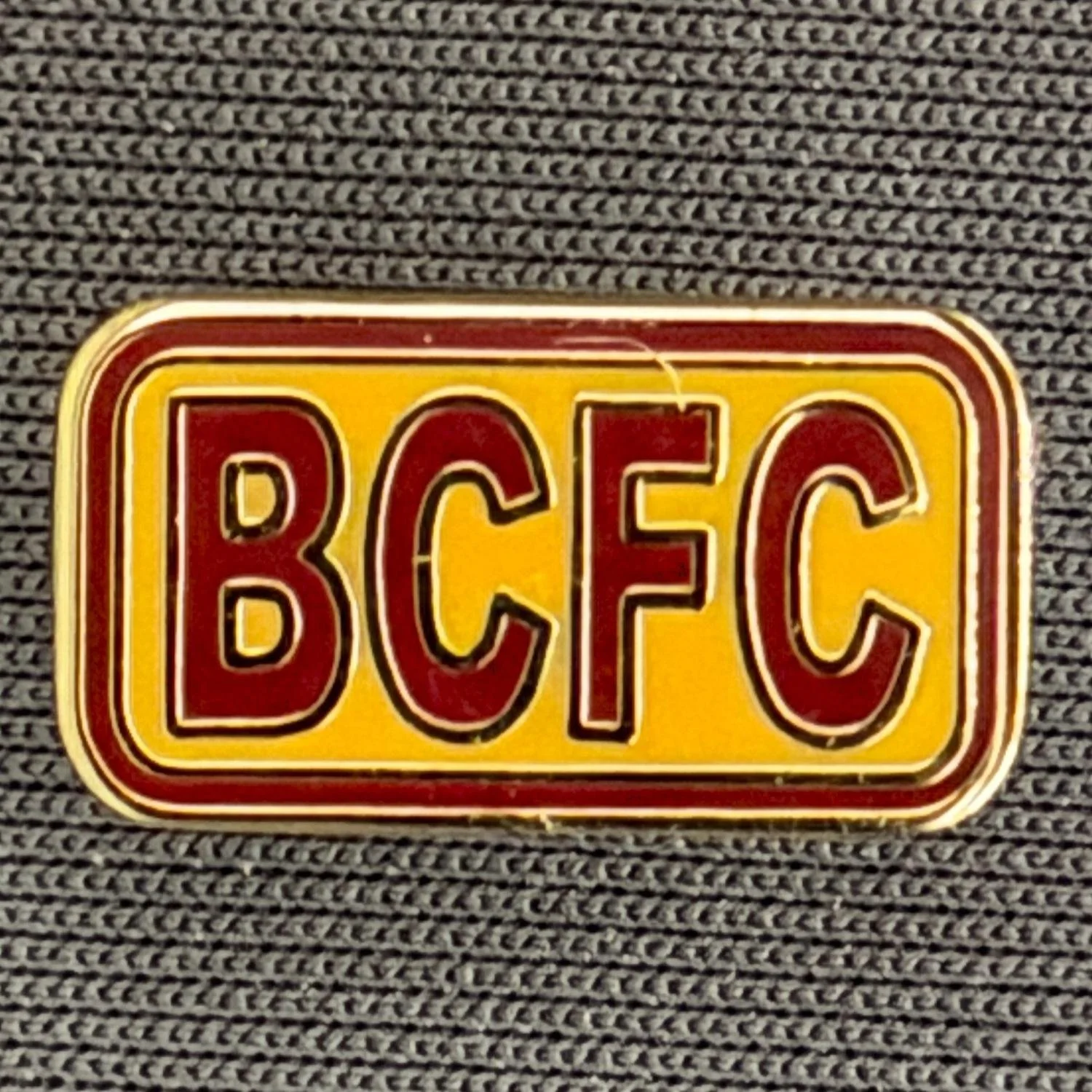 Reference Number: BCBCFC074
Size: H 8.5 mm x W 15.5 mm
Pin Type: Metal Clutch
Plating: Gold
Value: £4
Manufacturer: Unknown
Comments: BCFC Claret & Amber Version
