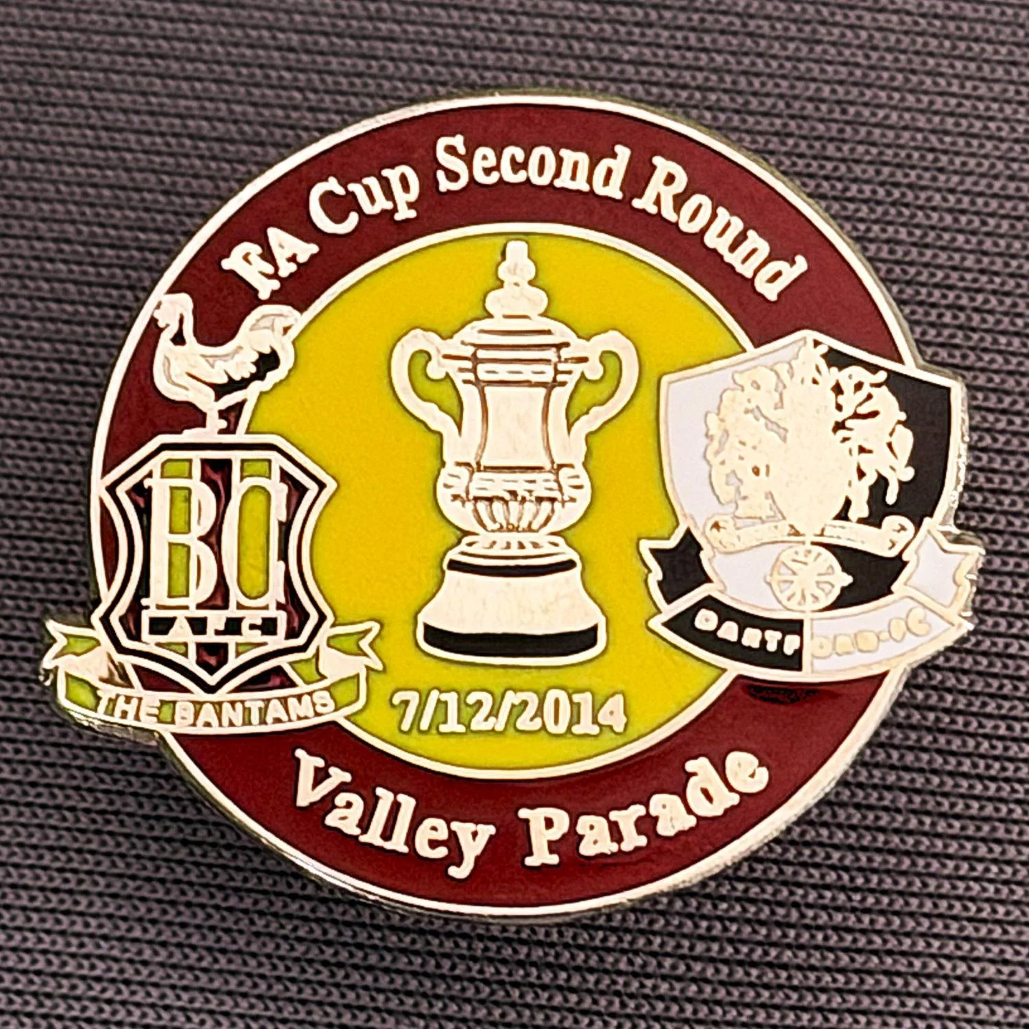Reference Number: BCFAC063
Size: H 23.3 mm x W 25.6 mm
Pin Type: Metal Clutch
Plating: Silver
Value: £4
Manufacturer: Dan Lloyd
Comments: F.A. Cup Second Round 2014/15, v Dartford, Claret & Amber Version