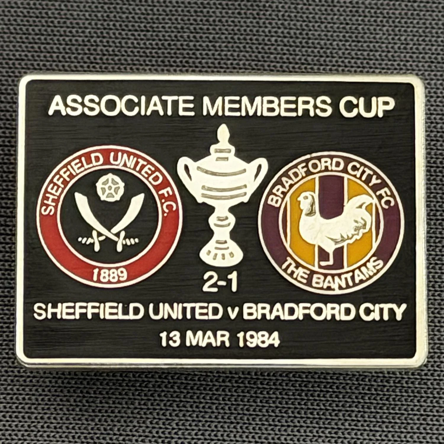 Reference Number: BCOFIX062
Size: H 18.9 mm x W 25.9 mm
Pin Type: Brooch Pin
Plating: Silver
Value: £6
Manufacturer: Unknown
Comments: Sheffield United v Bradford City Associate Members Cup 1984, Black Version