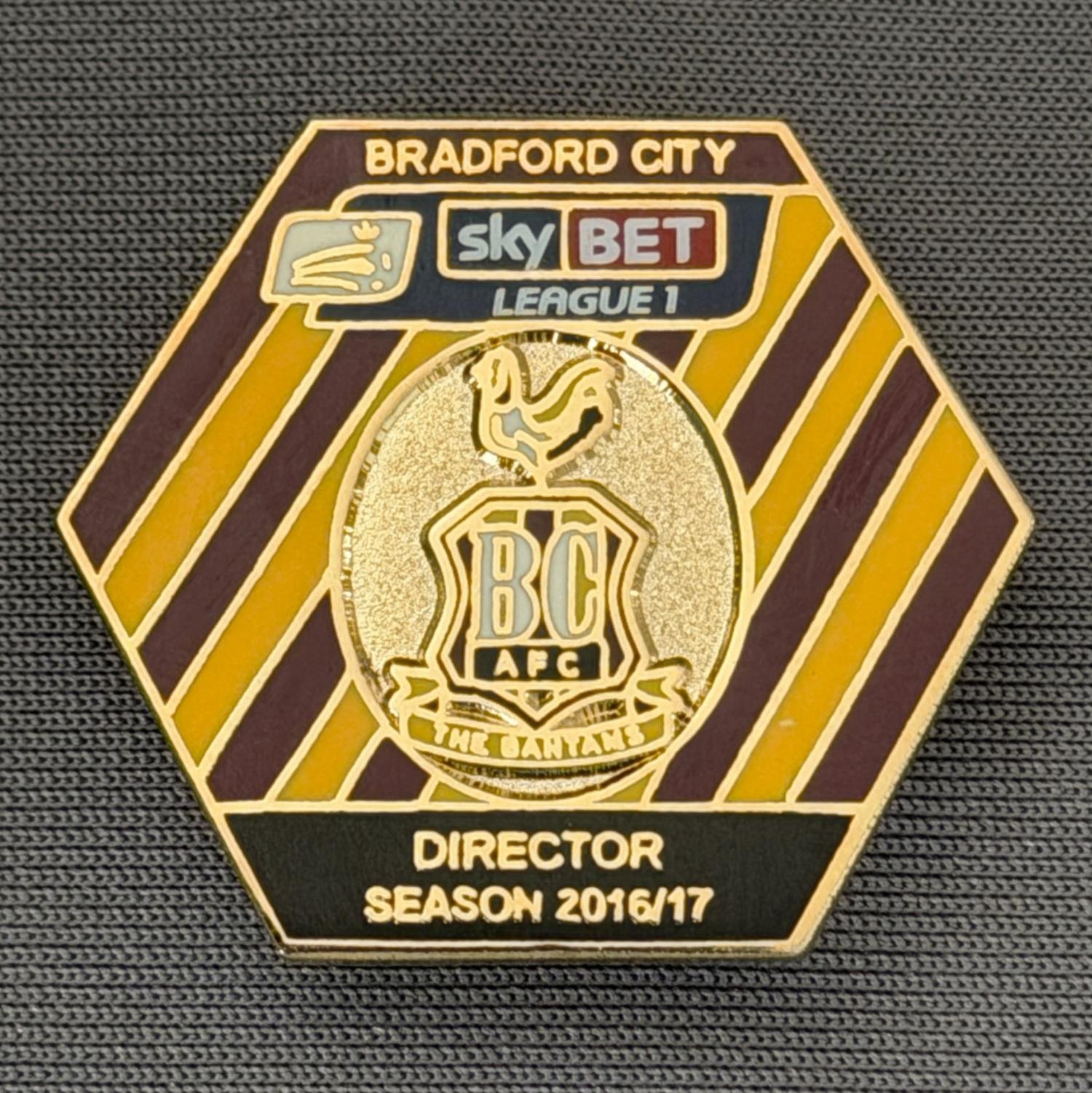 Reference Number: BCDIR011
Size: H 25.7 mm x W 29.5 mm
Pin Type: Brooch Pin
Plating: Gold
Value: £50
Manufacturer: Bradford City Badges
Comments: Worn by Edin Rahic & Stefan Rupp