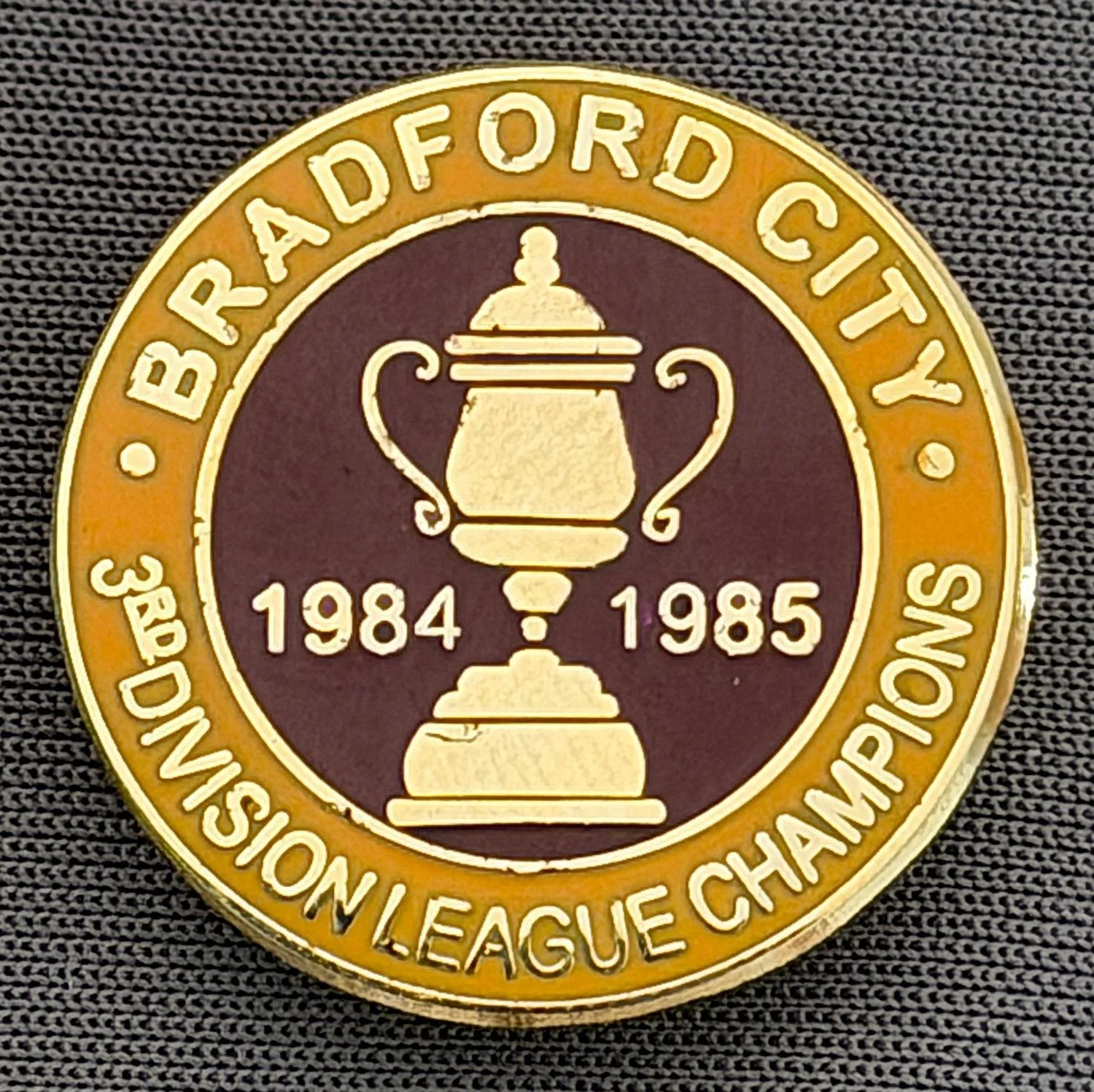 Reference Number: BCEVE027
Size: D 22.7 mm
Pin Type: Brooch Pin
Plating: Gold
Value: £8
Manufacturer: Unknown
Comments: 1984/85 3rd Division League Champions, Amber & Claret