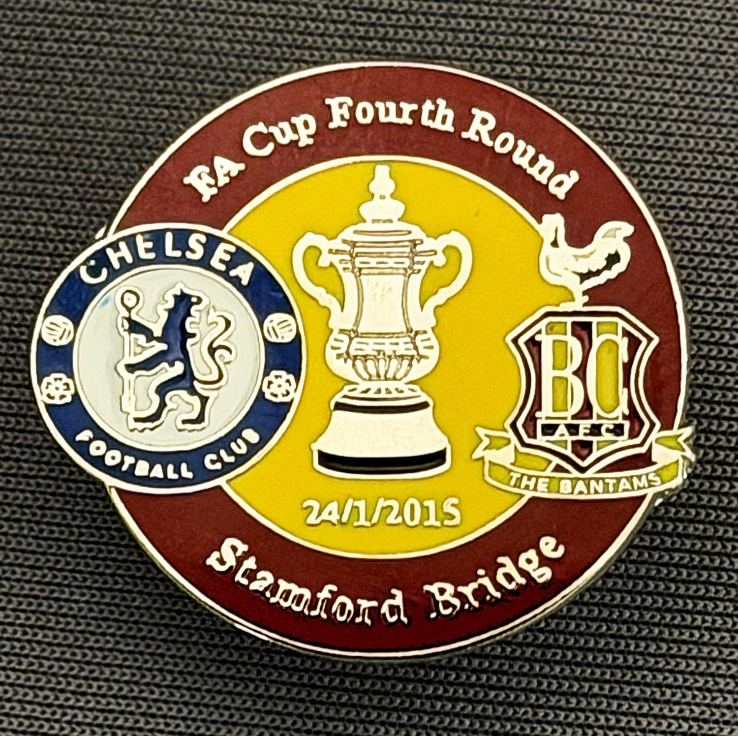 Reference Number: BCFAC086
Size: H 23.3 mm x W 25.3 mm
Pin Type: Metal Clutch
Plating: Silver
Value: £4
Manufacturer: Dan Lloyd
Comments: F.A. Cup Fourth Round 2014/15, Away v Chelsea, Claret & Amber Version