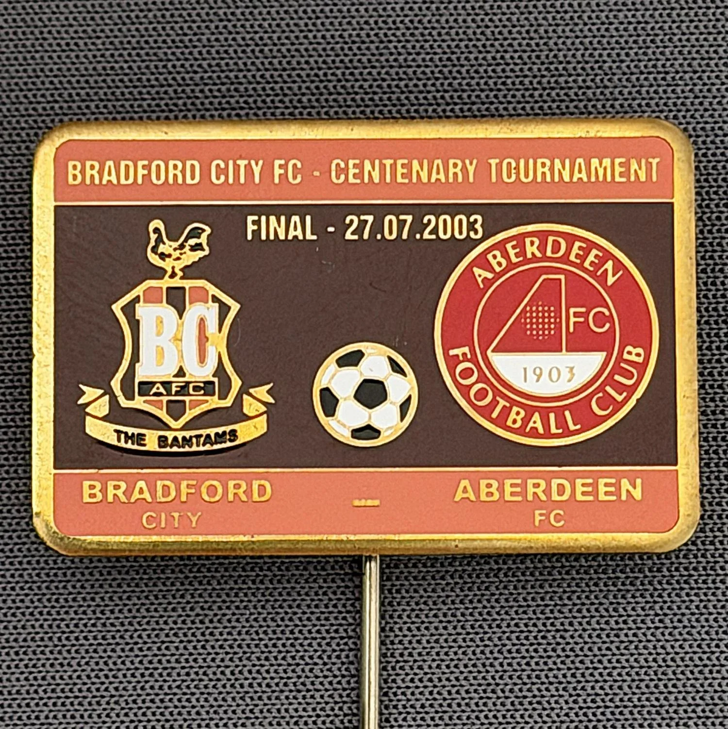 Reference Number: BCEVE023
Size: H 19.9 mm x W 30.1 mm
Pin Type: Stick Pin
Plating: Brass
Value: £12
Manufacturer: Russian
Comments: City v Aberdeen, Centenary Tournament 2003, Amber & Claret