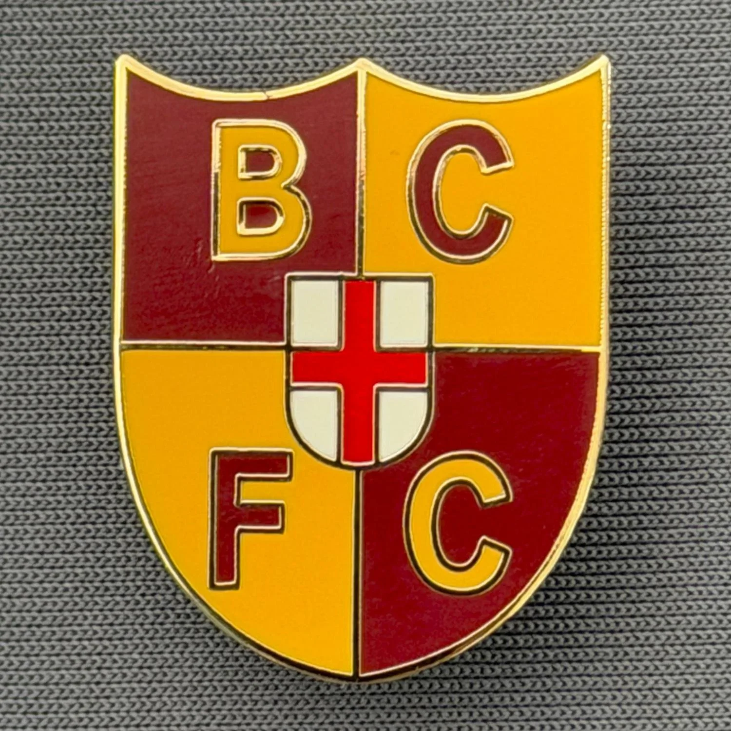 Reference Number: BCFLA018
Size: H 25 mm x W 20 mm
Pin Type: Brooch Pin
Plating: Gold
Value: £6
Manufacturer: Not Known
Comments: Claret & Amber Shield with BCFC & Inner St George Shield