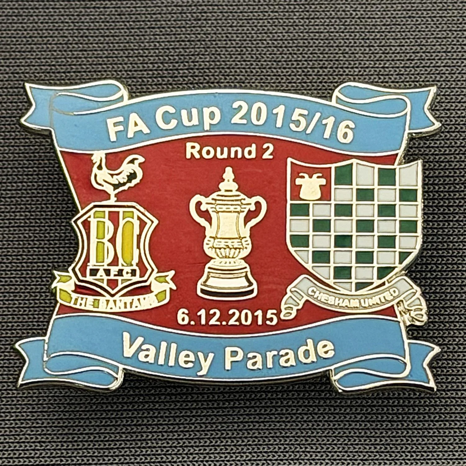 Reference Number: BCFAC147
Size: H 24.5 mm x W 32.5 mm
Pin Type: Metal Clutch
Plating: Silver
Value: £4
Manufacturer: Dan Lloyd
Comments: F.A. Cup Second Round 2015/16 v Chesham United, Blue & Red Version