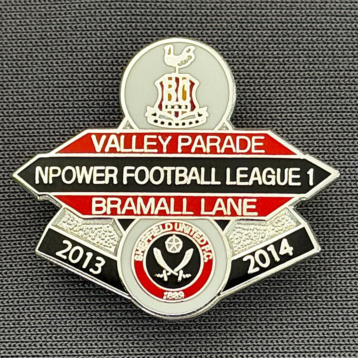 Reference Number: BCOFIX087
Size: H 22.5 mm x W 25.6 mm
Pin Type: Brooch Pin
Plating: Chrome
Value: £5
Manufacturer: Unknown
Comments: Bradford City v Sheffield United, League One, White, Red & Black Version
