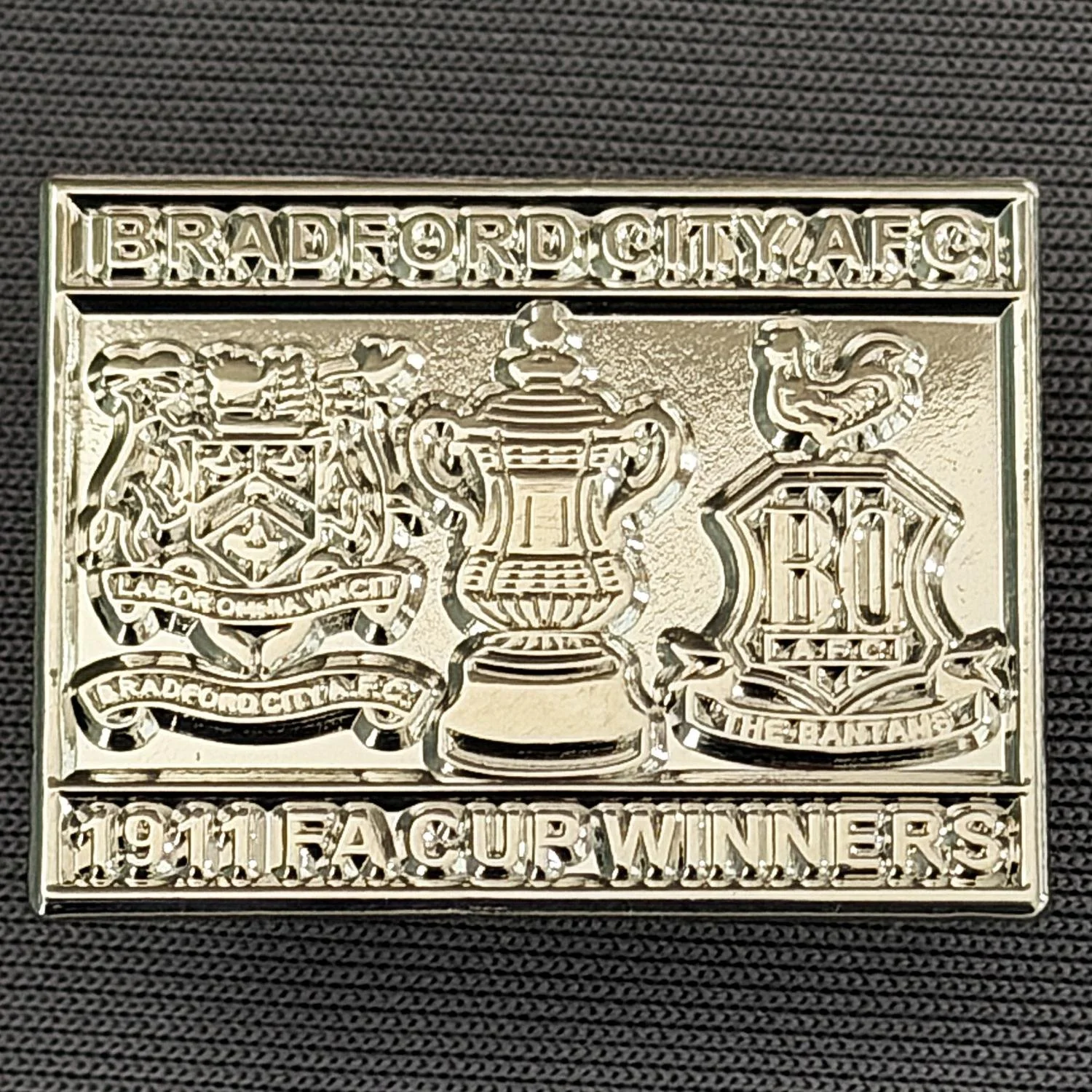 Reference Number: BCFAC040
Size: H 20.4 mm x W 26.8 mm
Pin Type: Metal Clutch
Plating: Silver
Value: £5
Manufacturer: Dan Lloyd
Comments: Bradford City 1911 F.A. Cup Winners, Silver Version