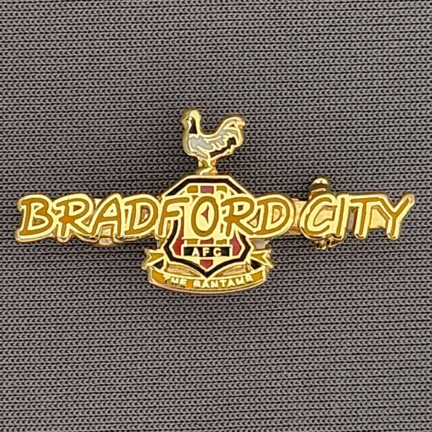 Reference Number: BCC&L045
Size: H 14 mm x 29.9 mm
Pin Type: Brooch Pin
Plating: Gold
Value: £8
Manufacturer: Unknown
Comments: Amber Bradford City Logo