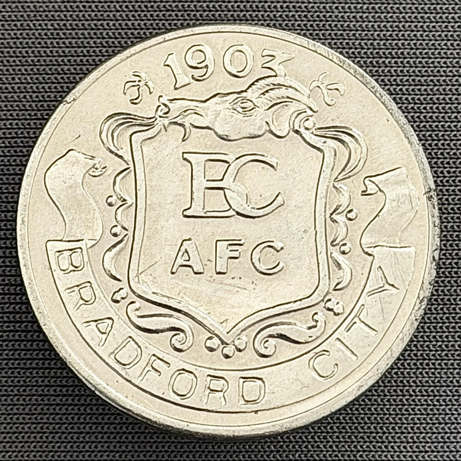 Reference Number: BCBCFC091
Size: D 27.1 mm
Pin Type: Metal Clutch
Plating: Silver
Value: £4
Manufacturer: Unknown
Comments: Bradford City 1903 2 Sided Converted Badge