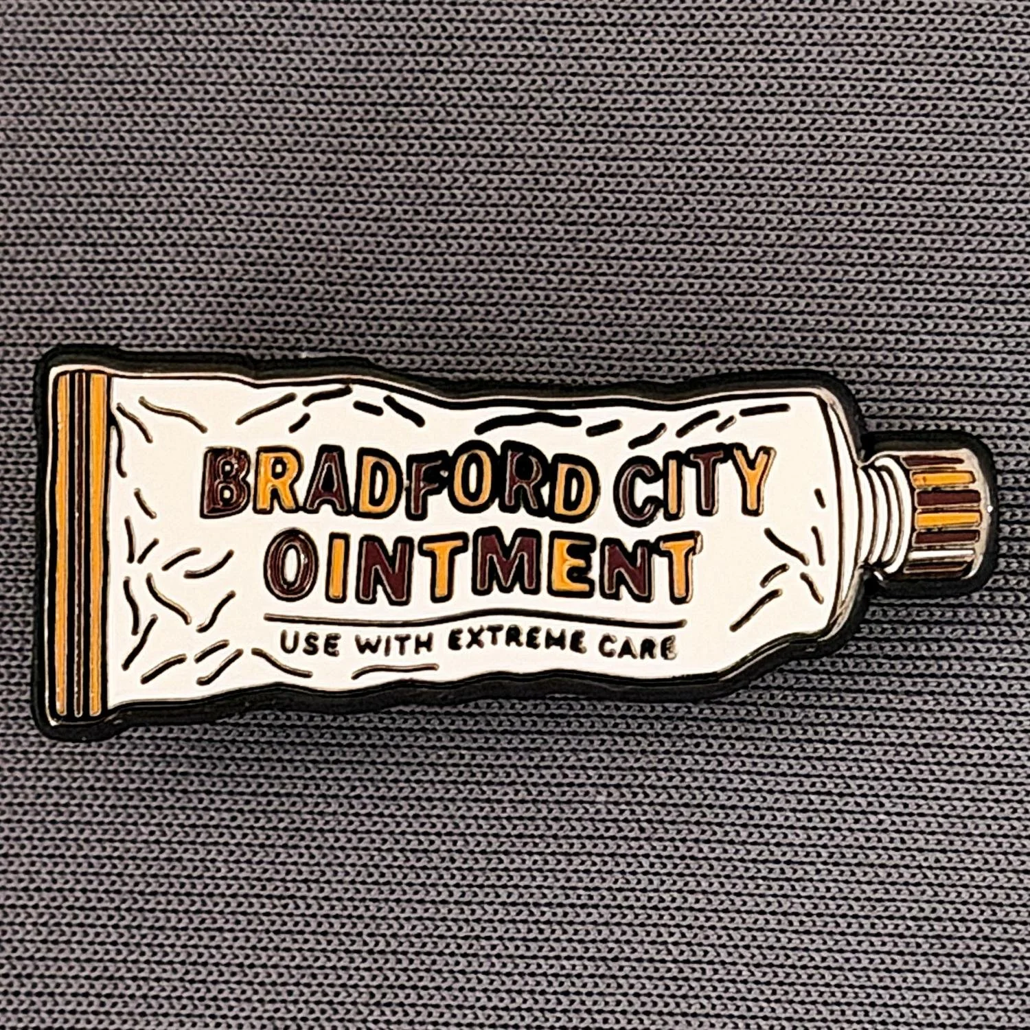 A tube of ointment labeled 'Bradford City Ointment' with a note stating 'Use with extreme care'.