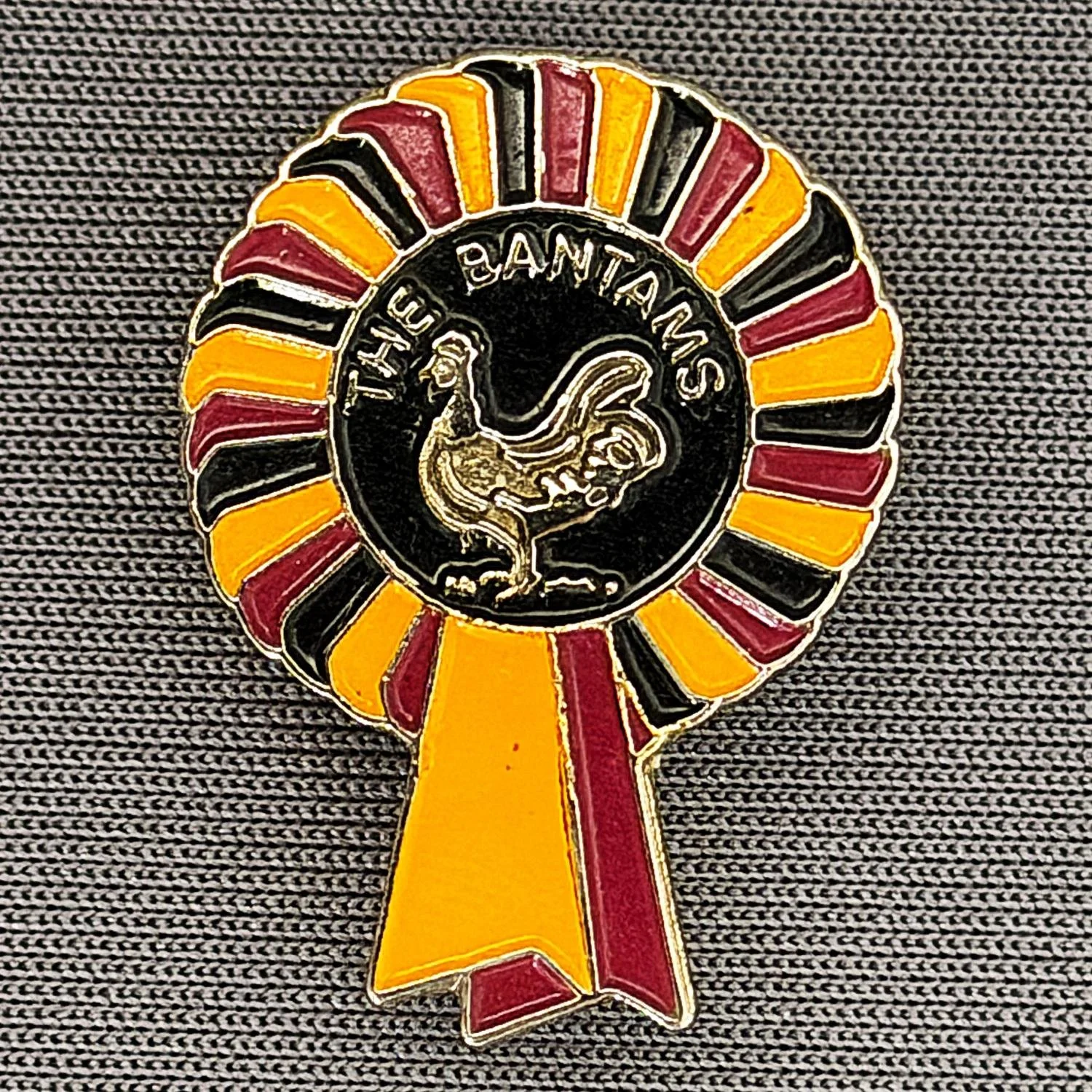 Reference Number: BCBAN008
Size: H 25 mm x W 18.2 mm
Pin Type: Brooch Pin
Plating: Gold
Value: £8
Manufacturer: Unknown
Comments: Bantams Rosette