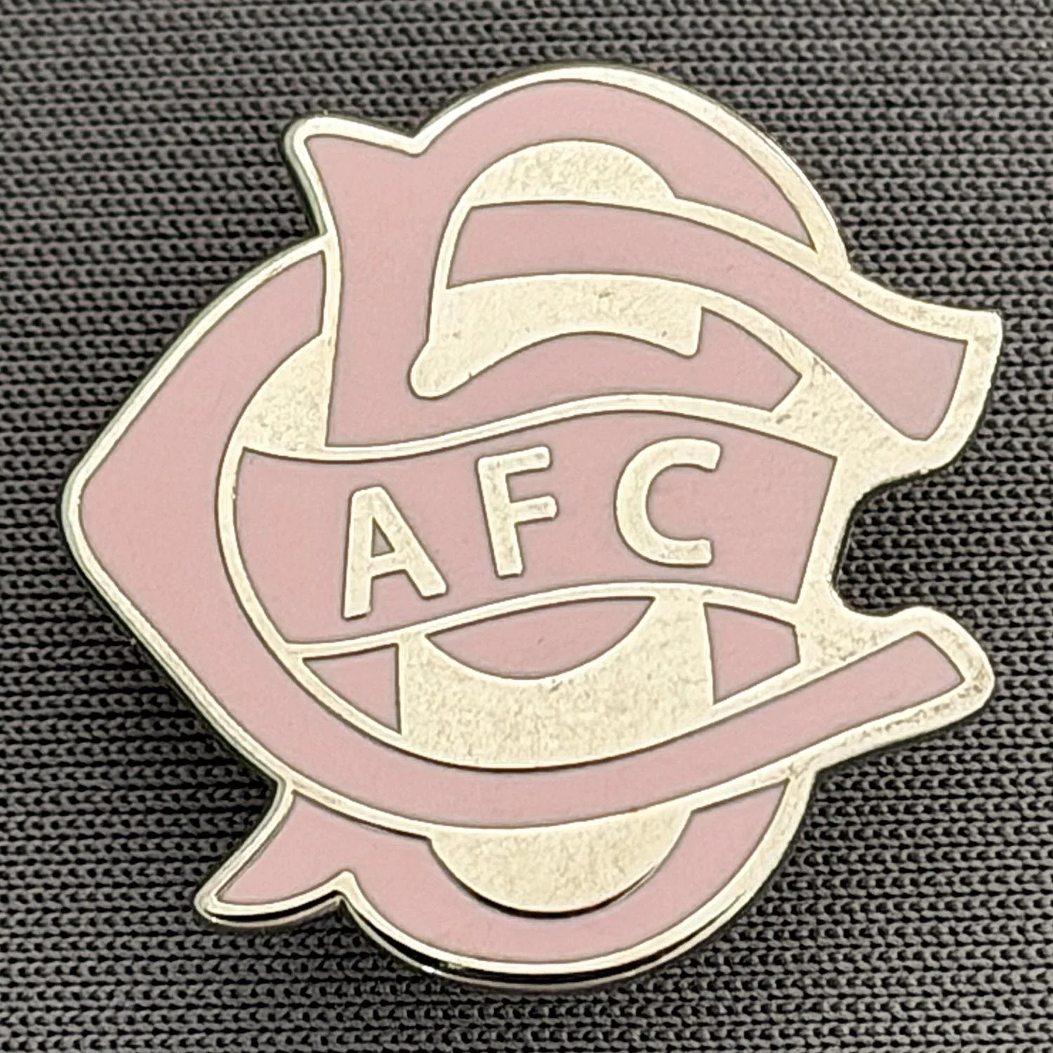 Reference Number: BCC&L069
Size: H 22.1 mm x 22  mm
Pin Type: Brooch Pin
Plating: Silver
Value: £6
Manufacturer: Unknown
Comments: BCFC Ayrton Scroll Pink