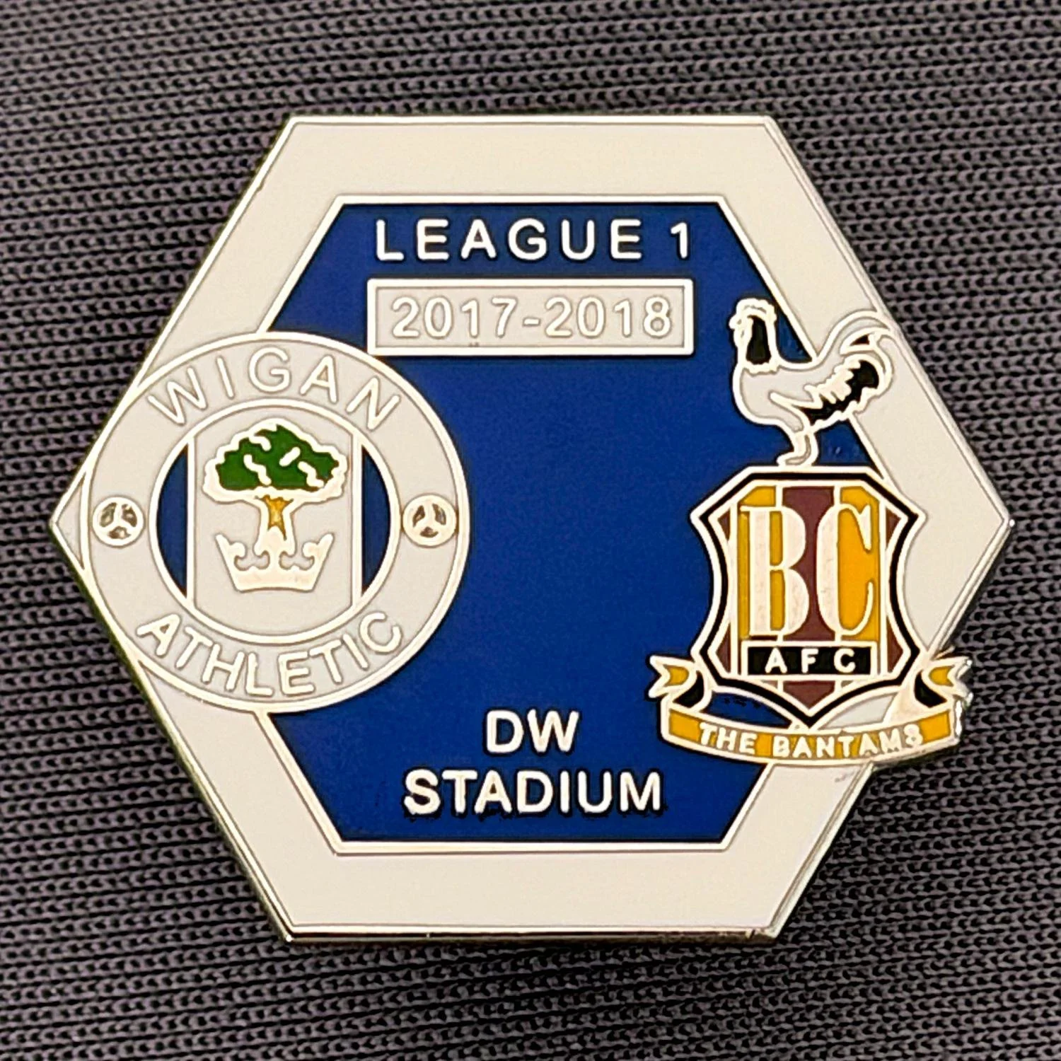 Reference Number: BCOFIX123
Size: H 21.6 mm x W 24.8 mm
Pin Type: Metal Clutch
Plating: Silver
Value: £5
Manufacturer: Unknown
Comments: Wigan v Bradford City, League One 2017/18, White & Blue Version 