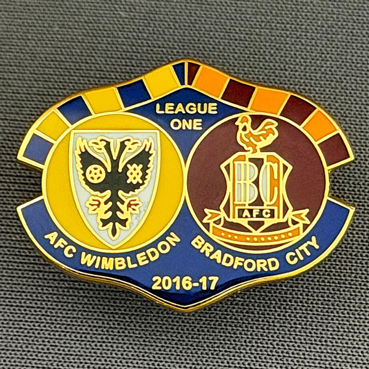 Reference Number: BCOFIX112
Size: H 19.3 mm x W 25.3 mm
Pin Type: Rubber Clutch
Plating: Gold
Value: £5
Manufacturer: Terry's Badges
Comments: A.F.C. Wimbledon v Bradford City, League One 2016/17