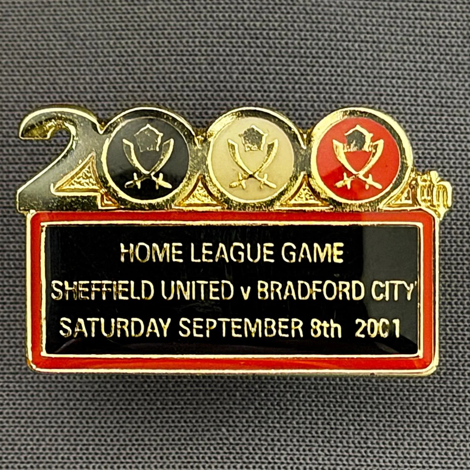 Reference Number: BCOFIX069
Size: H 17 mm x W 27.7 mm
Pin Type: Metal Clutch
Plating: Gold
Value: £8
Manufacturer: Unknown
Comments: Sheffield United v Bradford City, 2000th League Game 2001