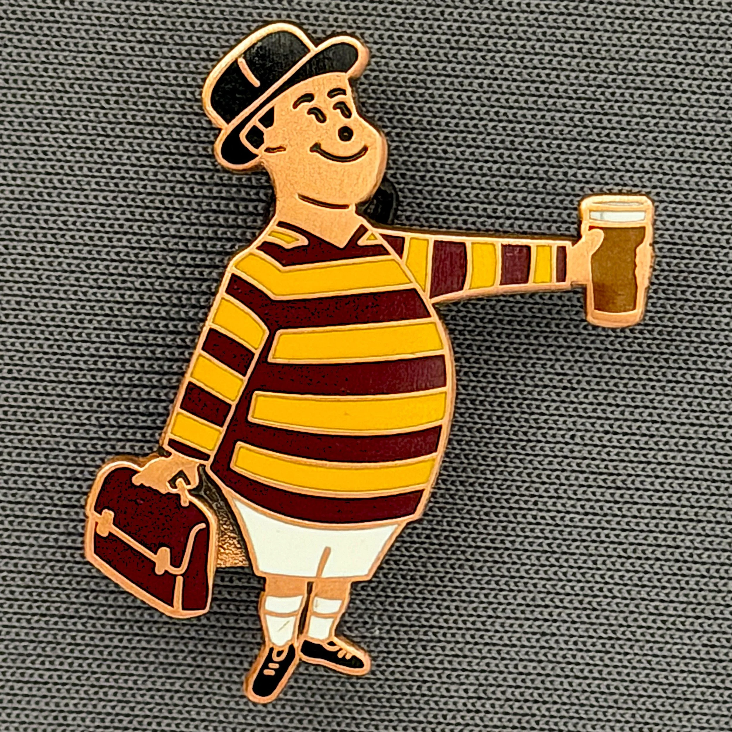 Reference Number: BCGEN070
Size: H 28.8 mm x W 20.9 mm
Pin Type: Brooch Pin
Plating: Antique Copper
Value: £20
Manufacturer: Bradford City Badges
Comments: City Gent Beer, Claret Briefcase. One Off Badge.